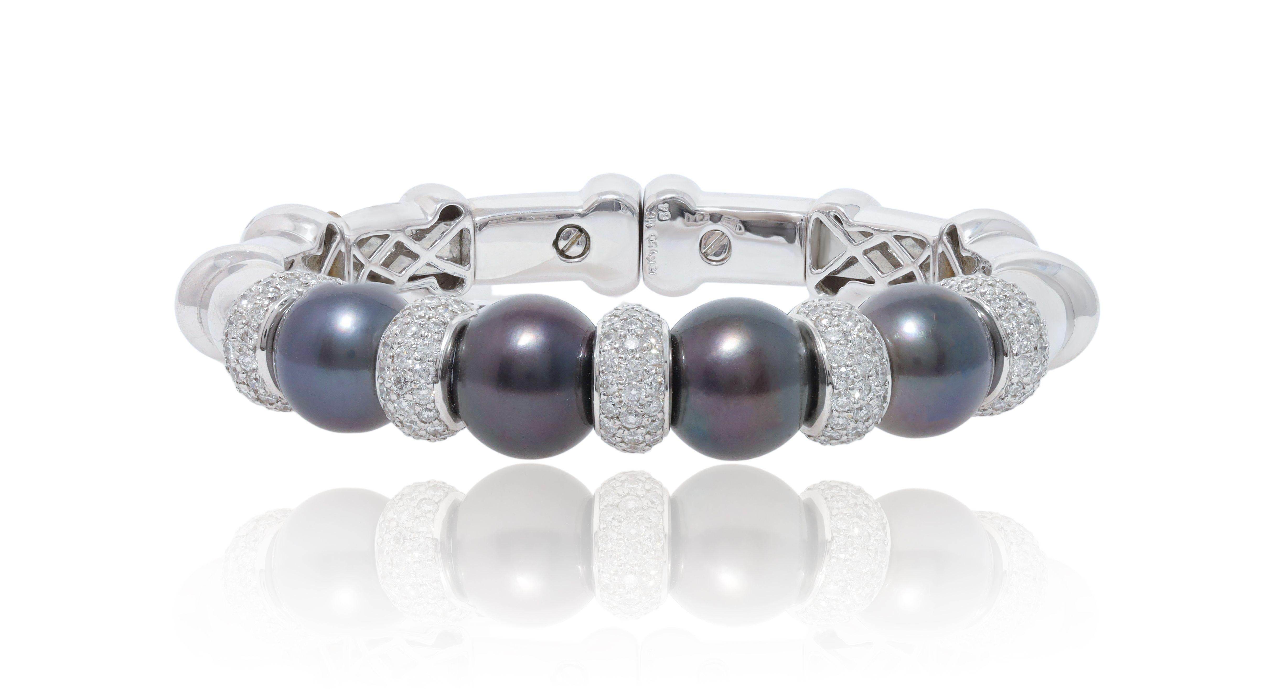 South Sea Pearl and Diamond Cuff Bangle with diamonds. 

18K white gold bracelet with rows of pavé diamonds, 4 south sea pearls with 3.00 Carats of diamonds. 

Length: 7