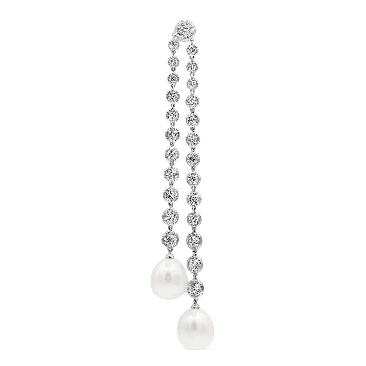 A elegant and magnificent dangle earrings featuring natural south sea pearls suspended on an 18k white gold chain bezel set with 50 round brilliant diamonds. Diamonds weigh 12.30 carats total. Perfectly made in 18k white gold.