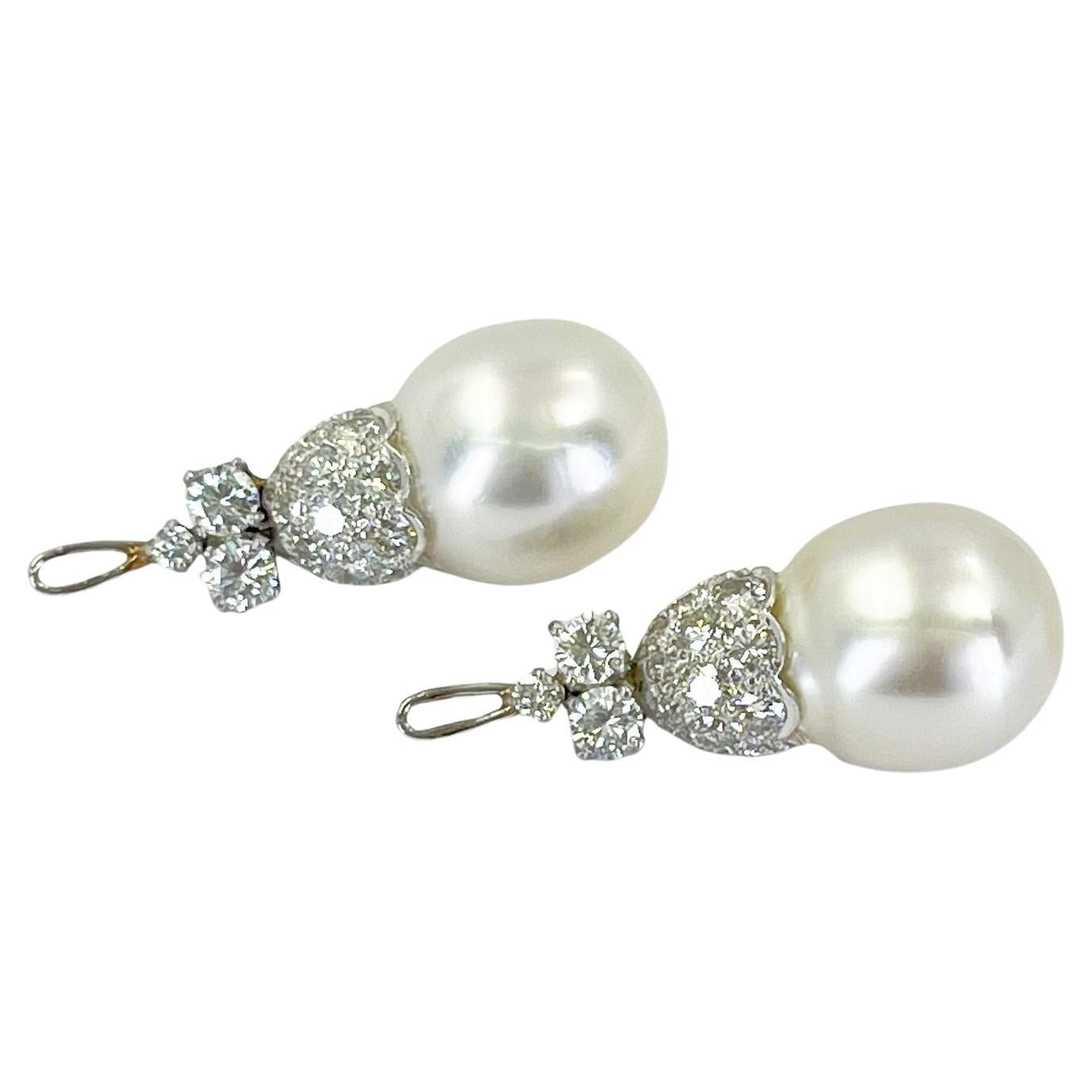 Add these platinum earring drop enhancers to any of your studs! The pair features two 12.5mm white South Sea cultured pearls accented by 35 round brilliant cut diamonds of VS clarity and G color totaling approximately 2.60 carats. 1.25 Inch Length.