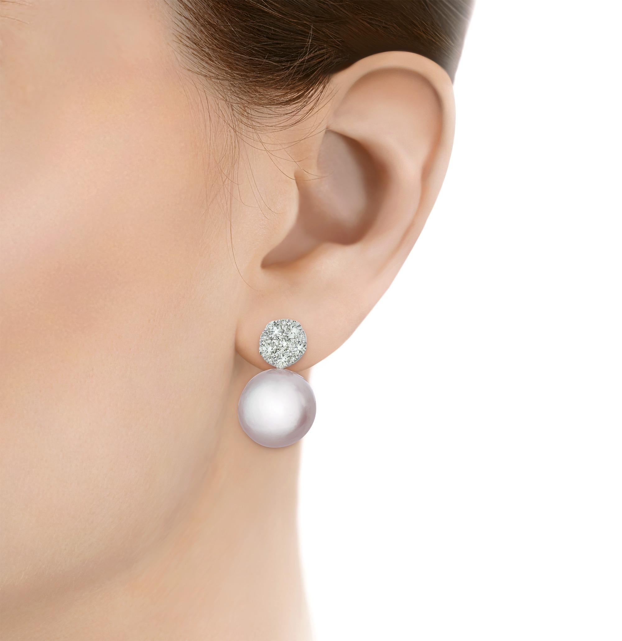 Elegant, refined and simply timeless, these beautiful earrings feature two of the sea's finest treasures, two 15-16mm South Sea pearls. The large and lustrous beauties drop down from sparkling clusters of white diamonds totaling 1.80 carats. Set in