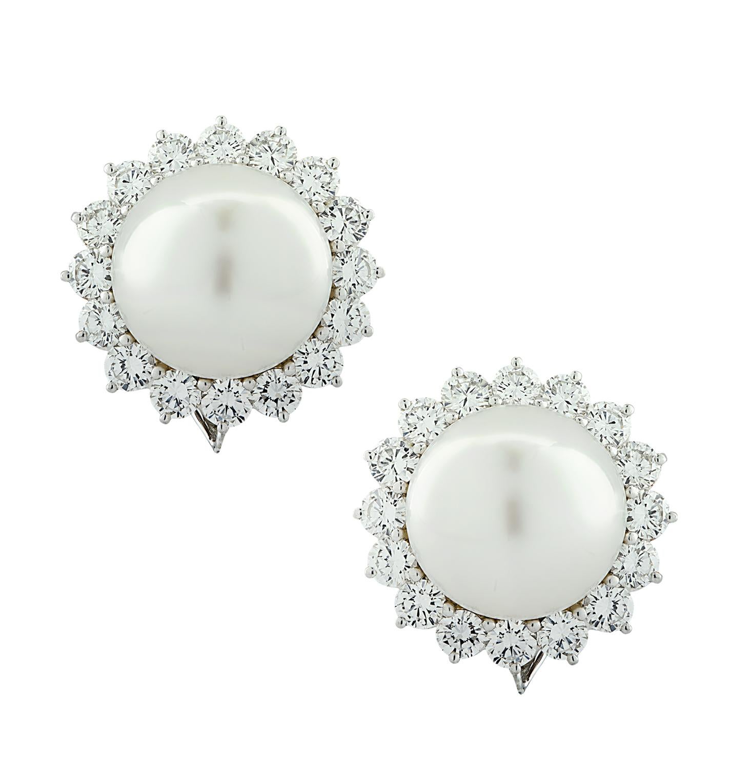 Beautiful diamond and pearl stud earrings crafted in platinum, showcasing two 15.5 mm South Sea pearls surrounded by 32 round brilliant cut diamonds weighing approximately 5 carats total F color, VS clarity. These gorgeous earrings measure .9 of an