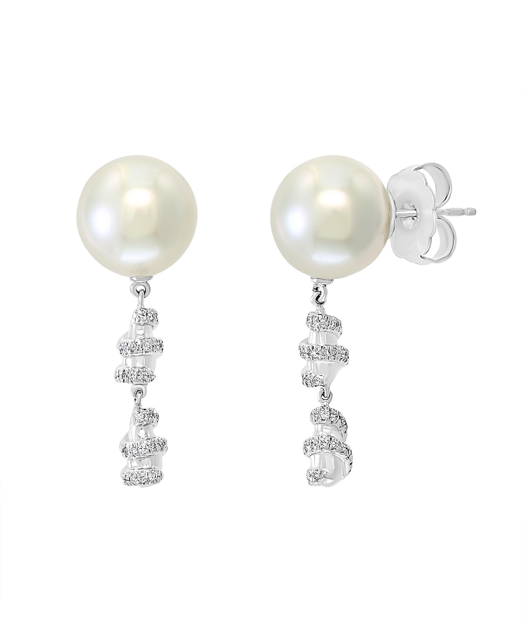 These elegant Diamond and Cultured Pearl earrings feature South Sea white round cultured pearls accentuated by diamonds set in 14k white gold. The classic design of these earrings is perfect for the working woman or for an evening out on the town.
-