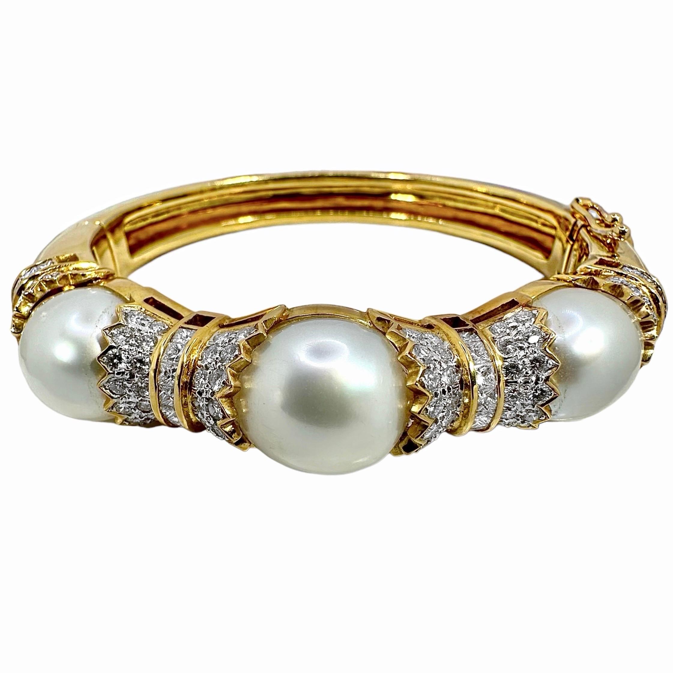 A strong yet wearable yellow gold bracelet centered around three cultured South Sea pearls. Each pearl nests between 2 end caps, which have been set with round brilliant cut diamonds. The end caps are separated by a row of channel set princess cut