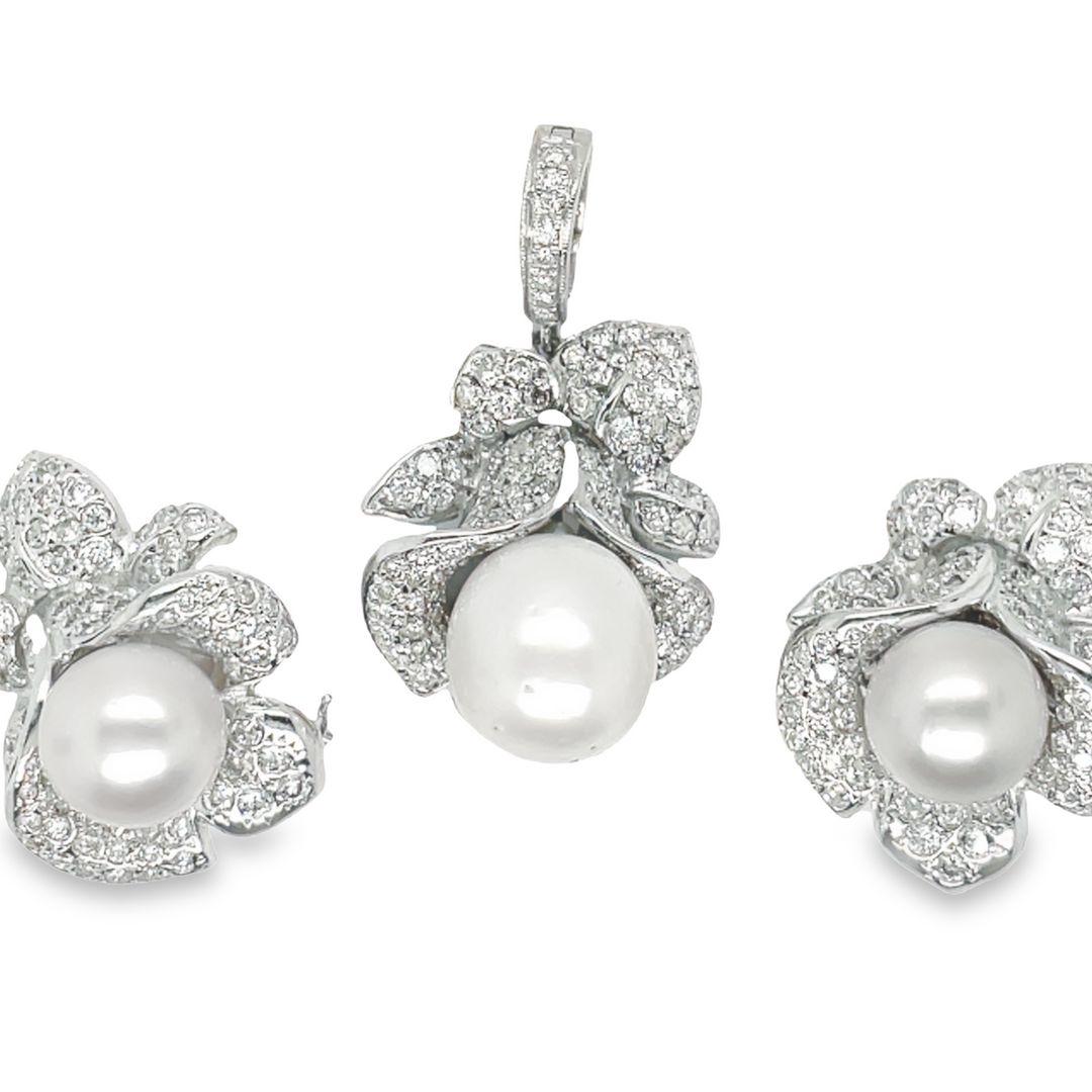 Beautifully sculpted flowers of 14-karat white gold and pavé diamond petals highlight luminous South Sea Pearl centers.

The clip earrings are set with 11 mm South Sea Pearls with a total diamond weight of approximately 2.88 carats.

The pearl