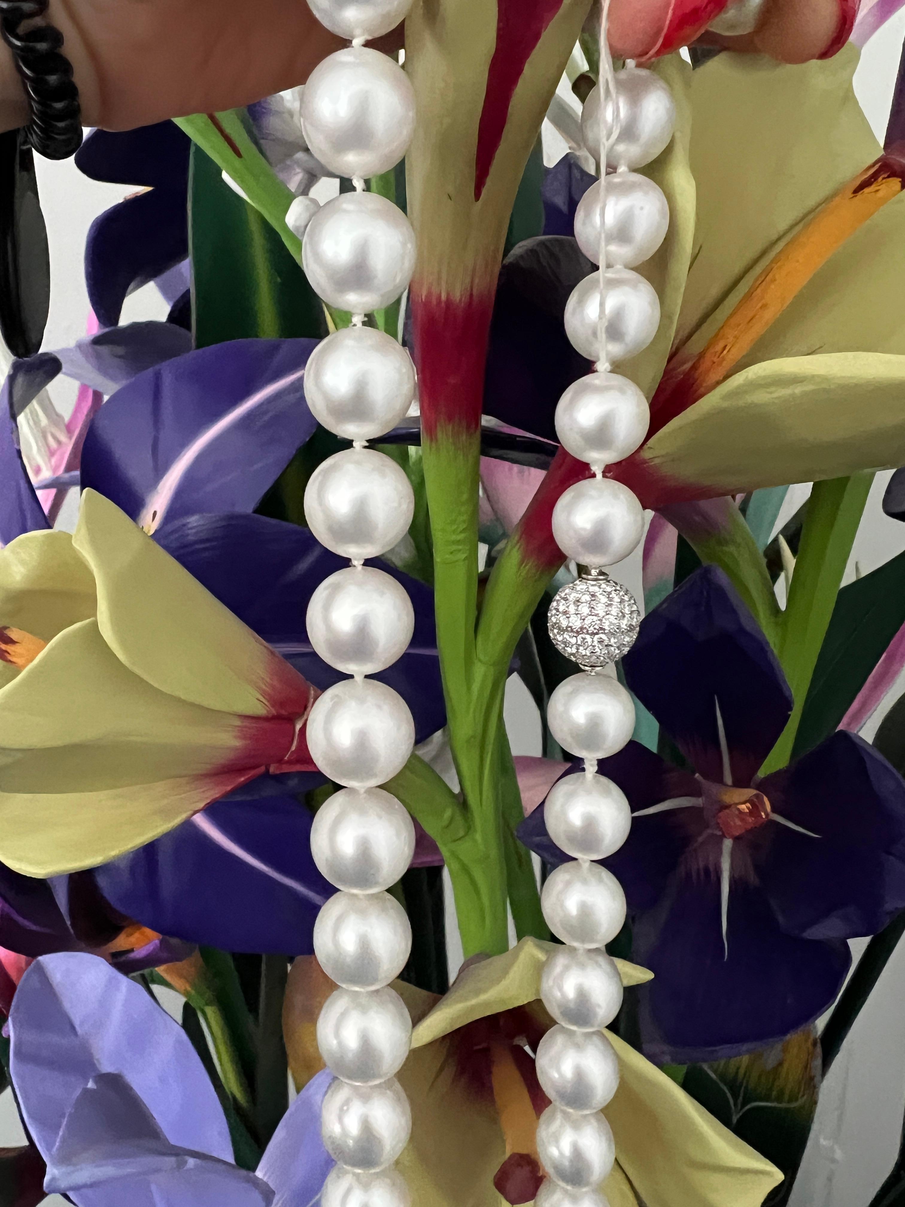 Graduated pearl necklace features 69 South Sea pearls ranging in size from 12.05mm to 14.75mm. The strand is completed with a 13mm platinum pave diamond clasp with 2.70 carats, G-H color, VS clarity

The pearls are 39 inches in length, allowing you