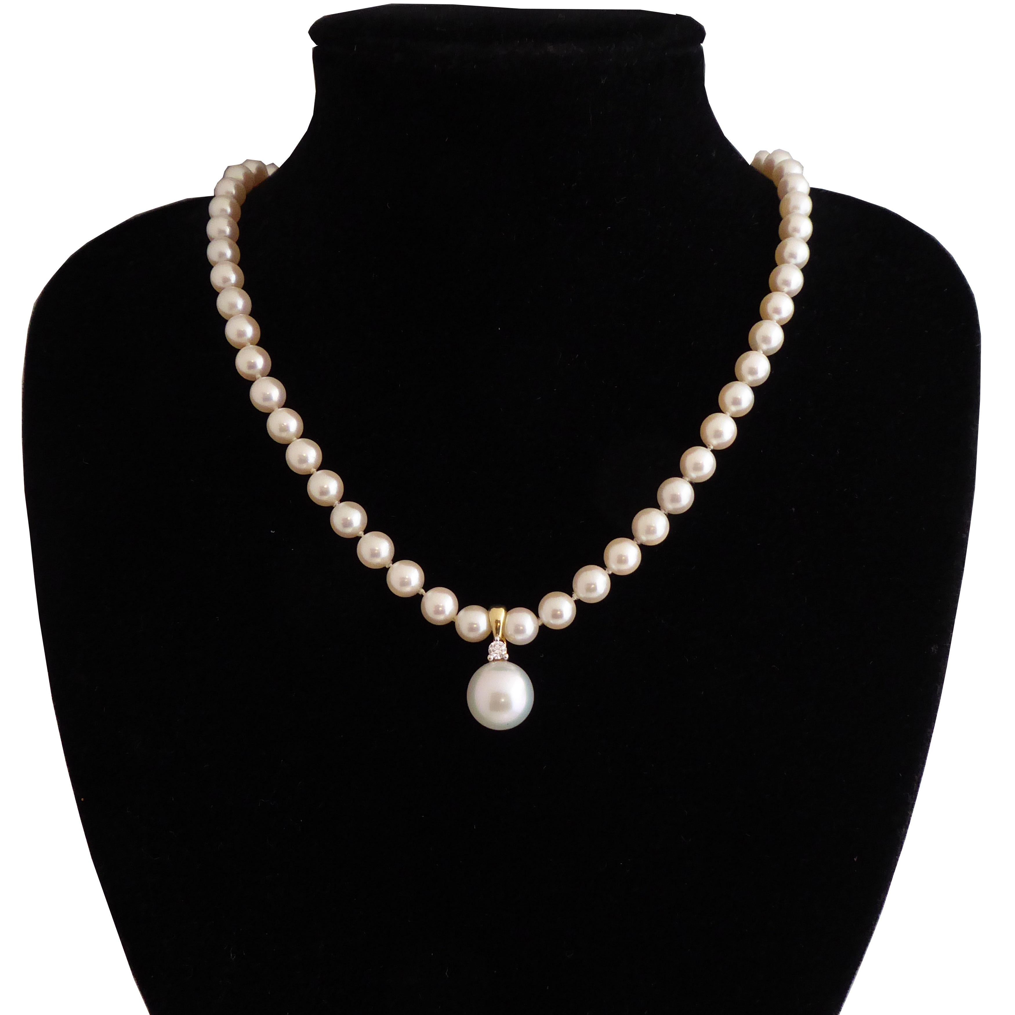 A South Sea pearl and diamond set pendant, consisting of a half-drilled cultured South Sea pearl measuring 12.1mm diameter, peg set to a yellow 