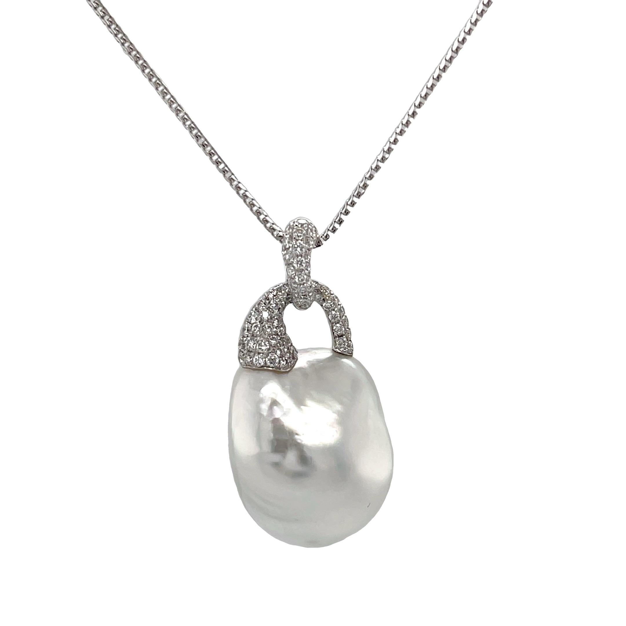 This exquisite, eye-catching necklace features an impressive South Sea white baroque pearl with gorgeous luster, set in 18k white gold with sparkling diamonds! The spectacular gem has lovely rainbow pearlescence and measures 22 x 18mm. Its elegant