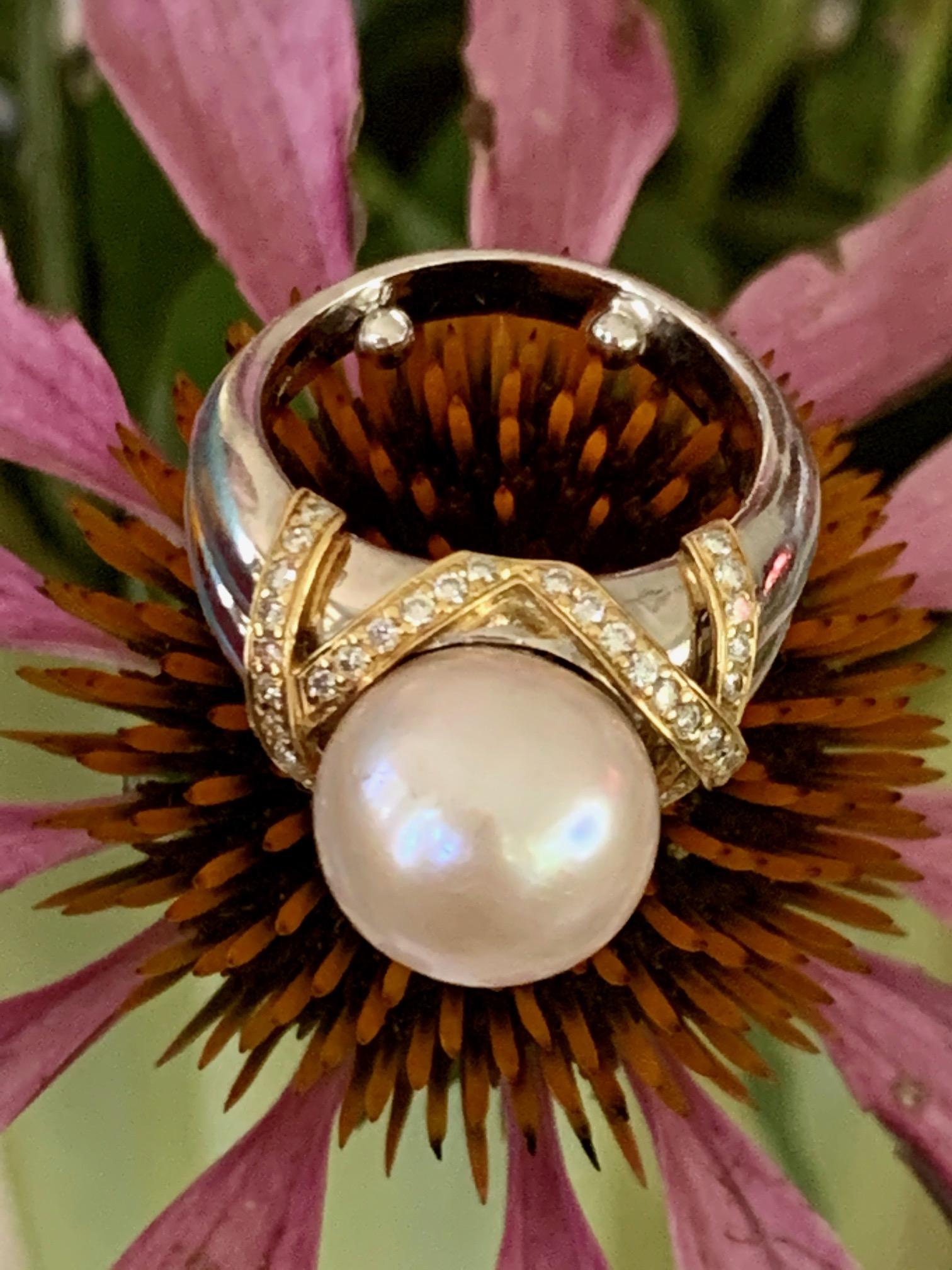 This ring makes a statement!  The center is a very large cream colored, South Sea Pearl measuring 11.5mm.   It is surrounded by an astounding 46-1.4mm brilliant cut Diamonds which total approximately .60ctw.

Size: 6 -  -This ring can be resized,