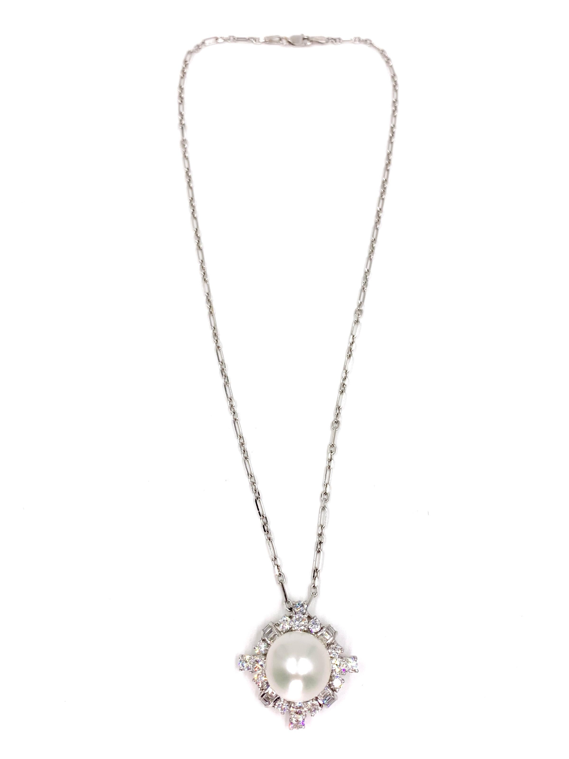 An exquisite find. This Art Deco inspired platinum pendant shows a generous amount of sparkle with 3.18 carats of high quality white diamonds surrounding a natural 13.75mm white South Sea pearl. Pendant is strung on a 14k white gold 16