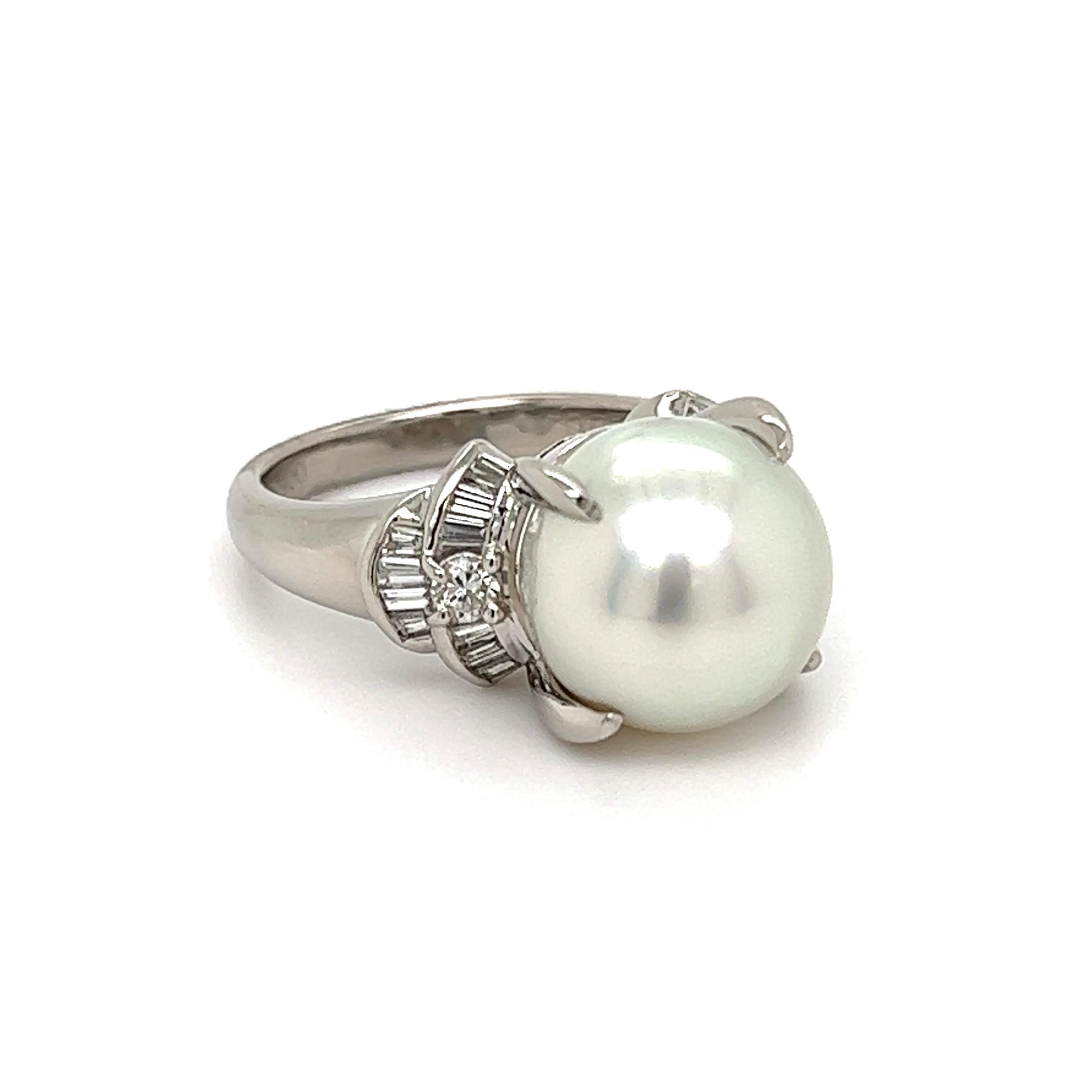 Simply Beautiful! Finely detailed South Sea Pearl and Diamond Cocktail Ring. Center securely nestled with a Hand set 11.2mm South Sea Pearl, either side Hand set with baguette and round Diamonds, weighing approx. 0.43 total carat weight. H color,