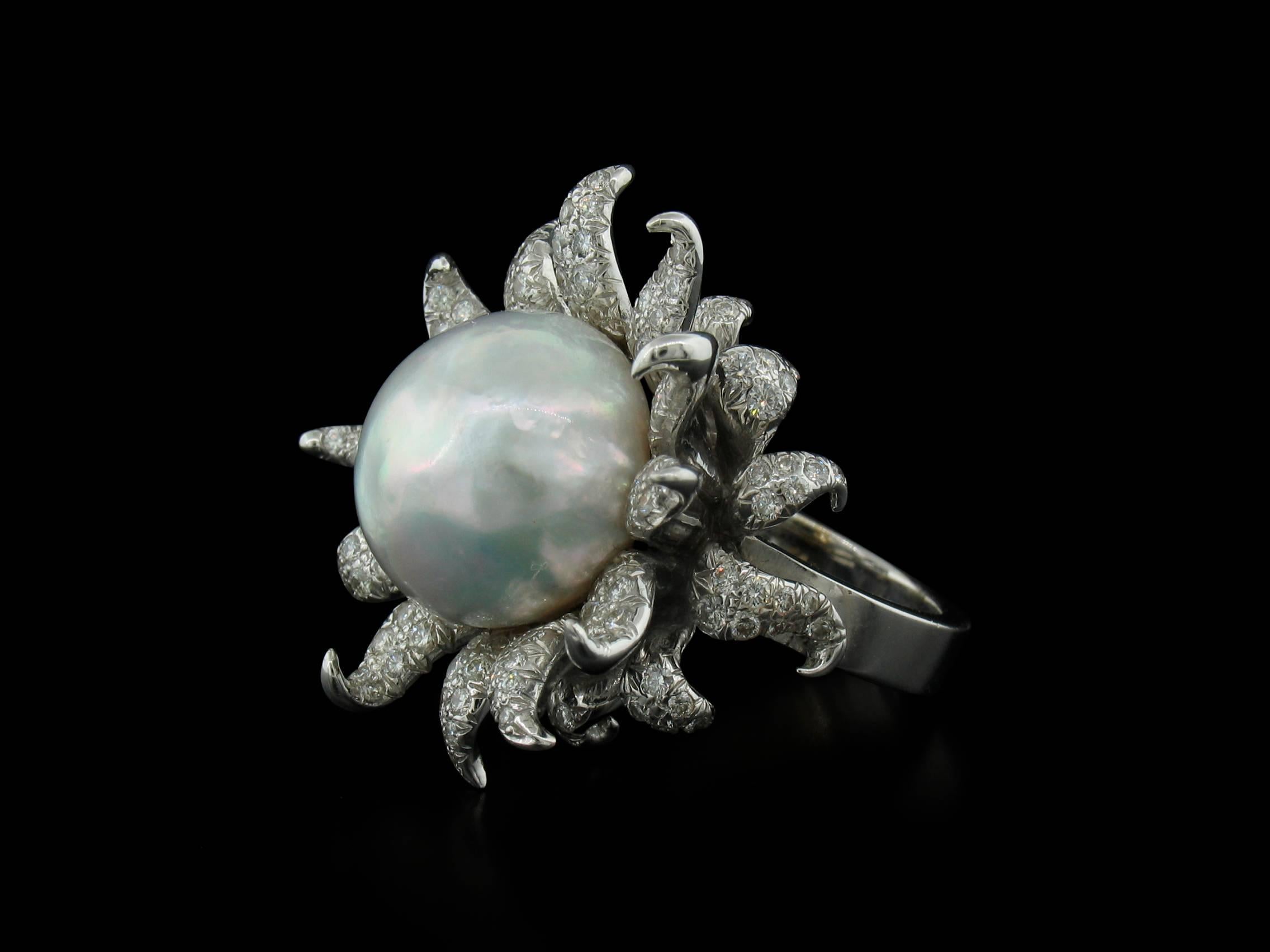 Tony Duquette South Sea Pearl ring resembles something akin to a sea urchin or a sunflower!  It features a central pearl measuring approximately 16.5mm in diameter and 2.39 carats in Diamond pave.  18K white gold.  Size 6 1/2
**This ring may be