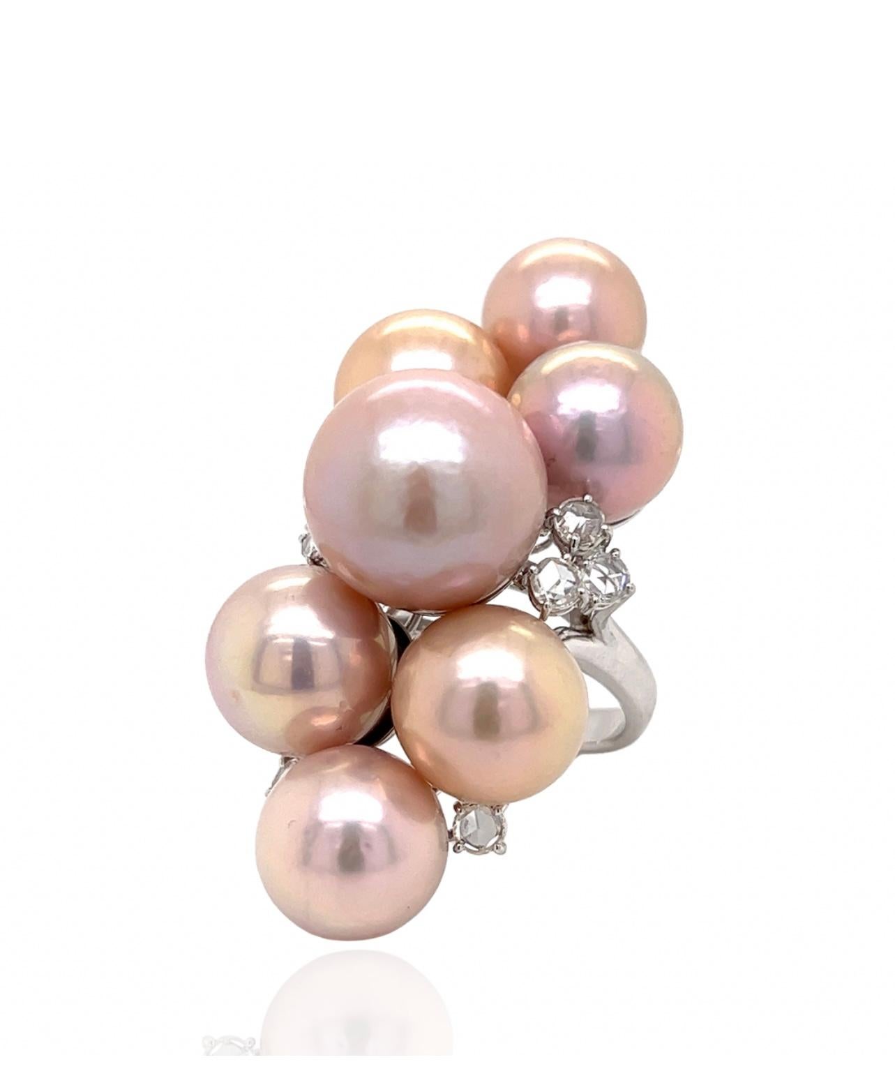 This extraordinary south sea pearl ring features seven luminous rose to light rose pearls.  The pearls are 12-15.5 mm in size.  There is 1.20 ctw in rose cut diamonds.  They are G-H-I in color, VS1-SI1 in clarity.  Set in 30 grams of 18Kt white