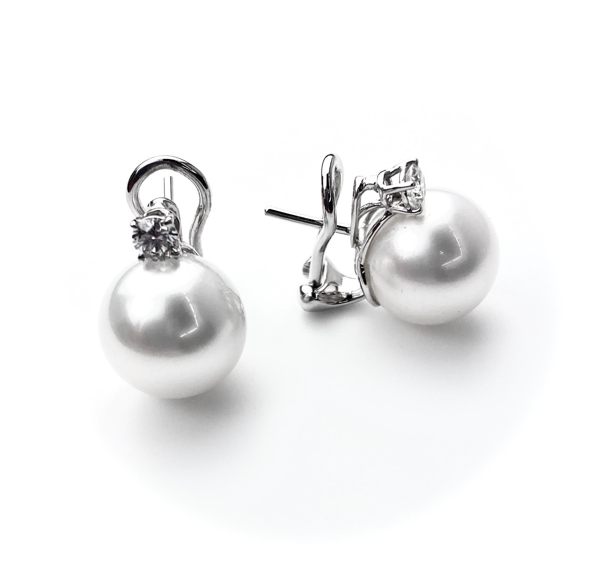 12.5-13mm white South Sea pearl studs set with two diamonds equal to 0.48ct total. Set in 18kt white gold backings, completed with post and omega backings.