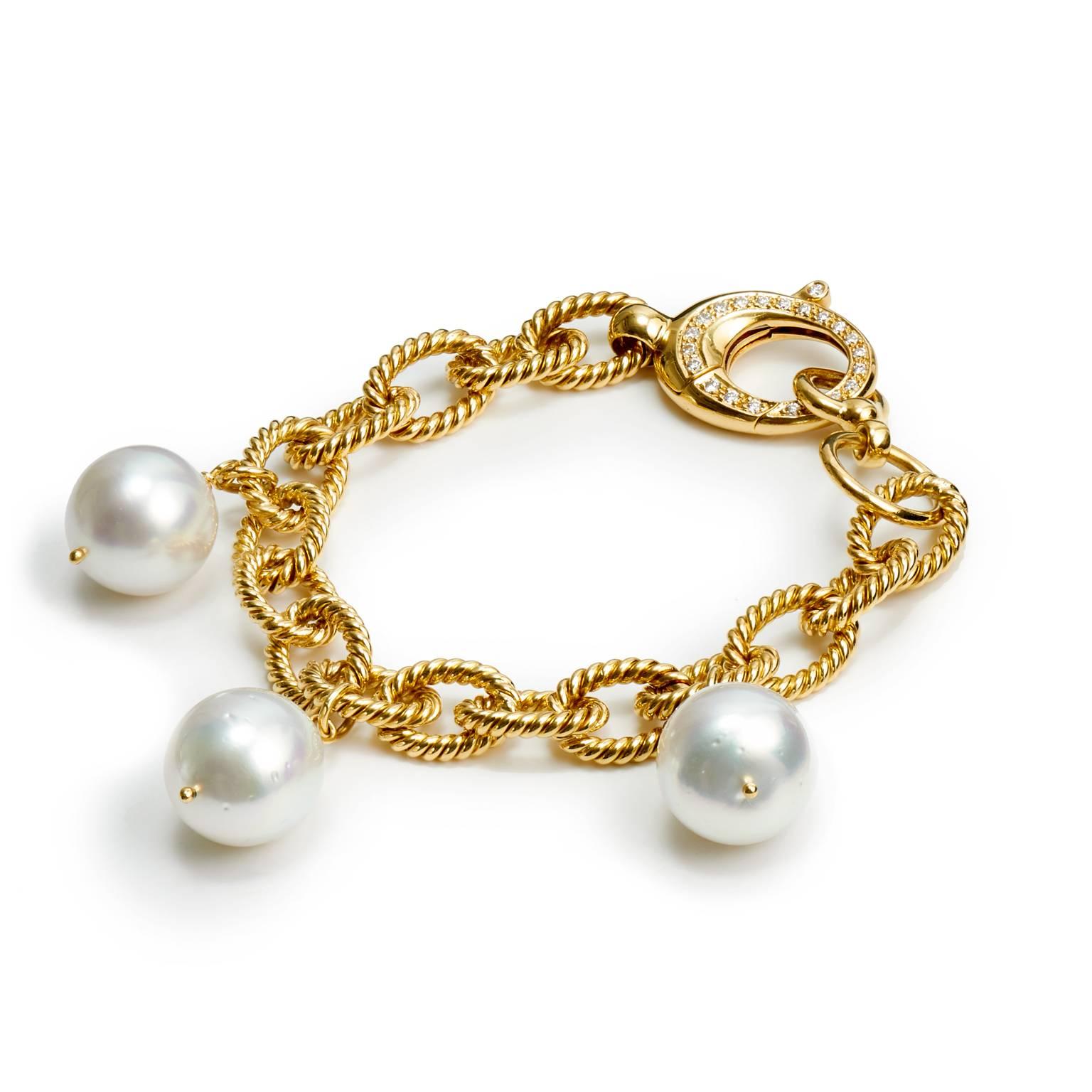 18 karat yellow gold bracelet with a rope-like appearance interlacing knots featuring three 14.2 to 13.2 millimeter South Sea pearls with a 0.06 carat diamond clasp.