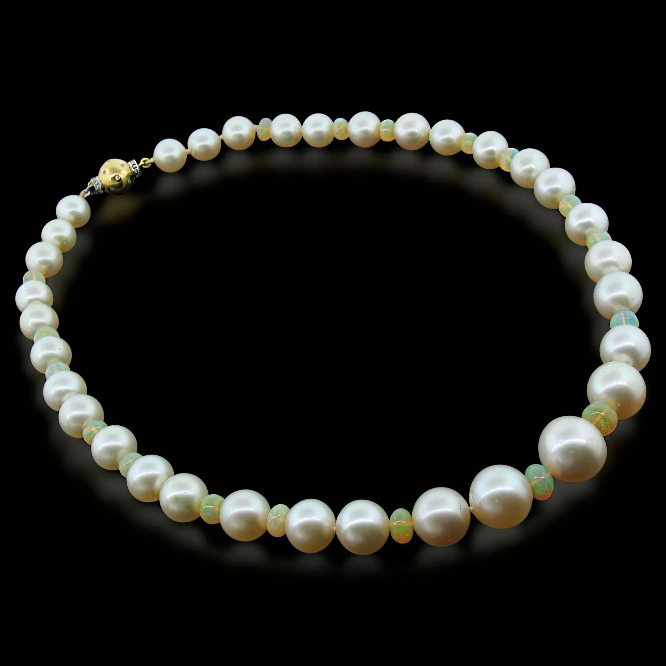 Creamy, round South Sea Pearls are strung on silk and alternated with warm Fire Opal rondells weighing a total of 19.56 carats.  It fastens with a beautiful 18k yellow gold clasp with Diamond accents.  18