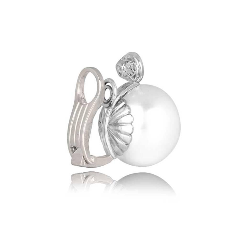 Indulge in elegance with these beautiful earrings showcasing round South Sea pearls boasting a mesmerizing high luster. Crowned with grace, each pearl is accented by a bezel-set old European cut diamond. The combined diamond weight is around 1.50