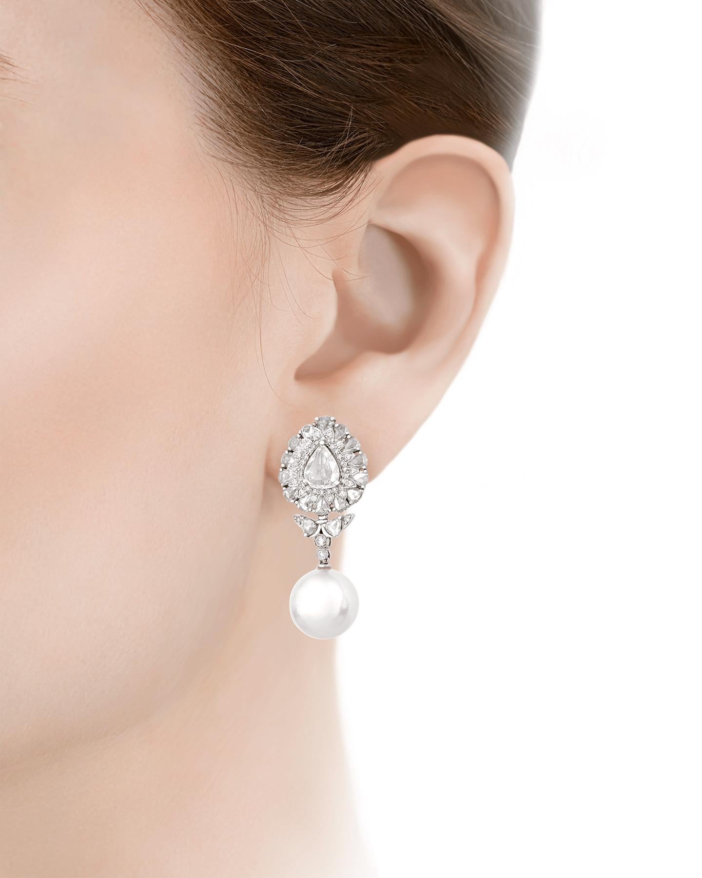 Rose-cut diamonds and lustrous white South Sea pearls are perfectly paired in these dazzling dangle earrings. Measuring 13mm, the pearls display the exceptional luminescence for which South Sea pearls are renowned, while the 3.68 total carats of