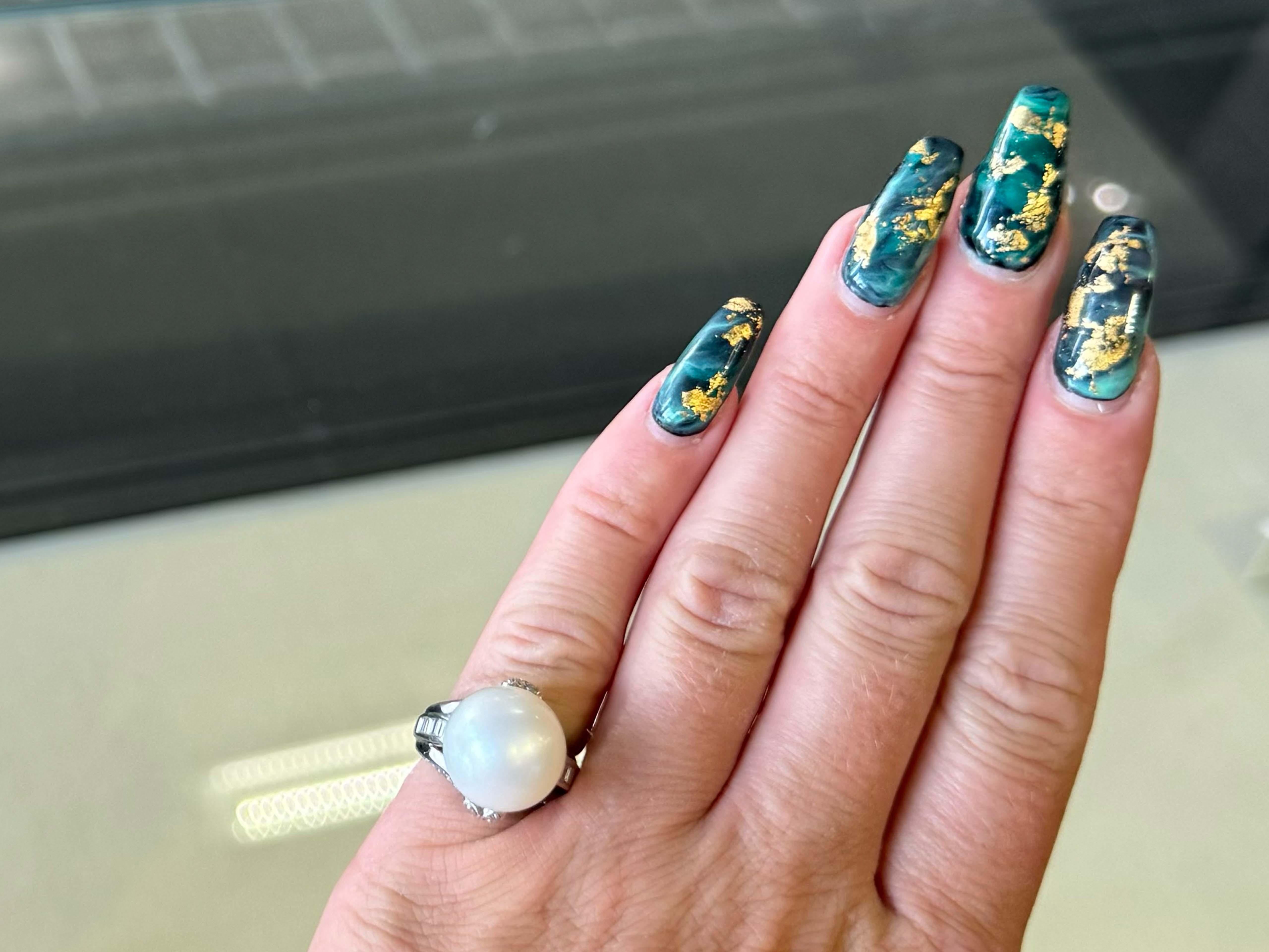 Ring Specifications:

Metal: 14k White Gold

Total Weight: 9.3 Grams

Pearl Diameter: 13.7 mm

Pearl Type: South Sea Pearl

Diamond Count: 15 baguette, 22 brilliant cut

Diamond Color: G-H

Diamond Clarity: VS2-SI2

Diamond Carat Weight: 0.35