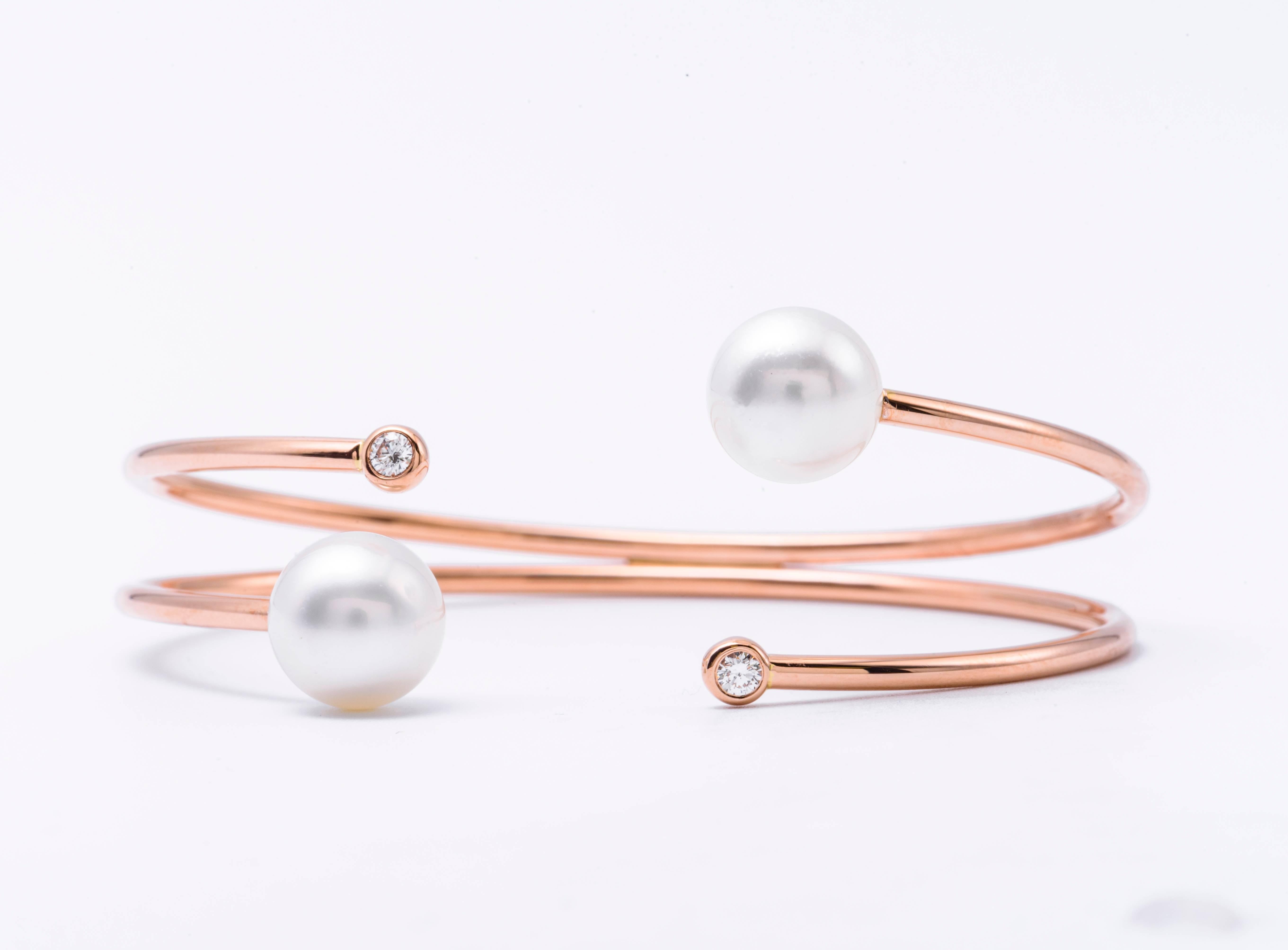 18K Rose gold bangle bracelet featuring two South Sea Pearls measuring 9.50-10 mm each and 2 round brilliants weighing 0.12 carats. 
Color G-H
Clarity SI

Pearls can be changed to Pink, Tahitian or Golden upon request. Price subject to change.