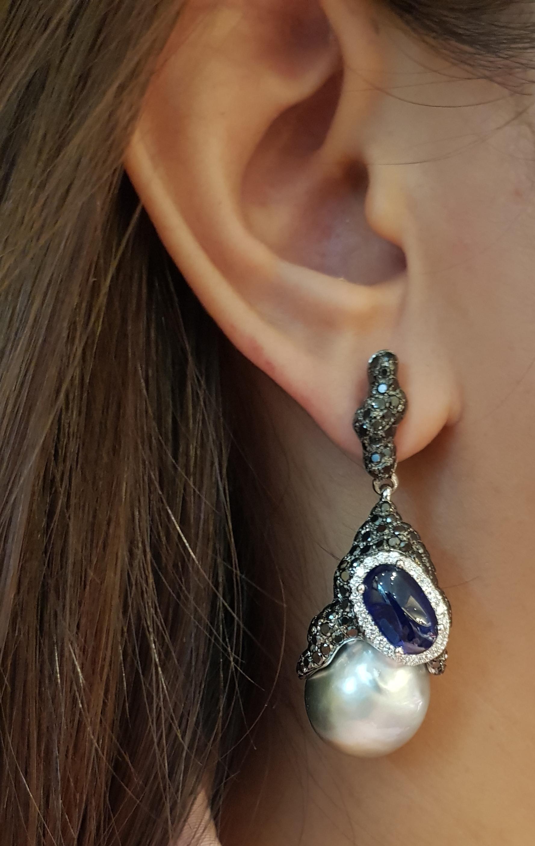 South Sea Pearl, Cabochon Blue Sapphire 6.40carats, Black Diamond  4.55 carats and Diamond 0.50 carat Earrings set in 18 Karat White Gold Settings

Width:  2.0 cm 
Length:  5.1 cm
Total Weight: 34.95 grams

