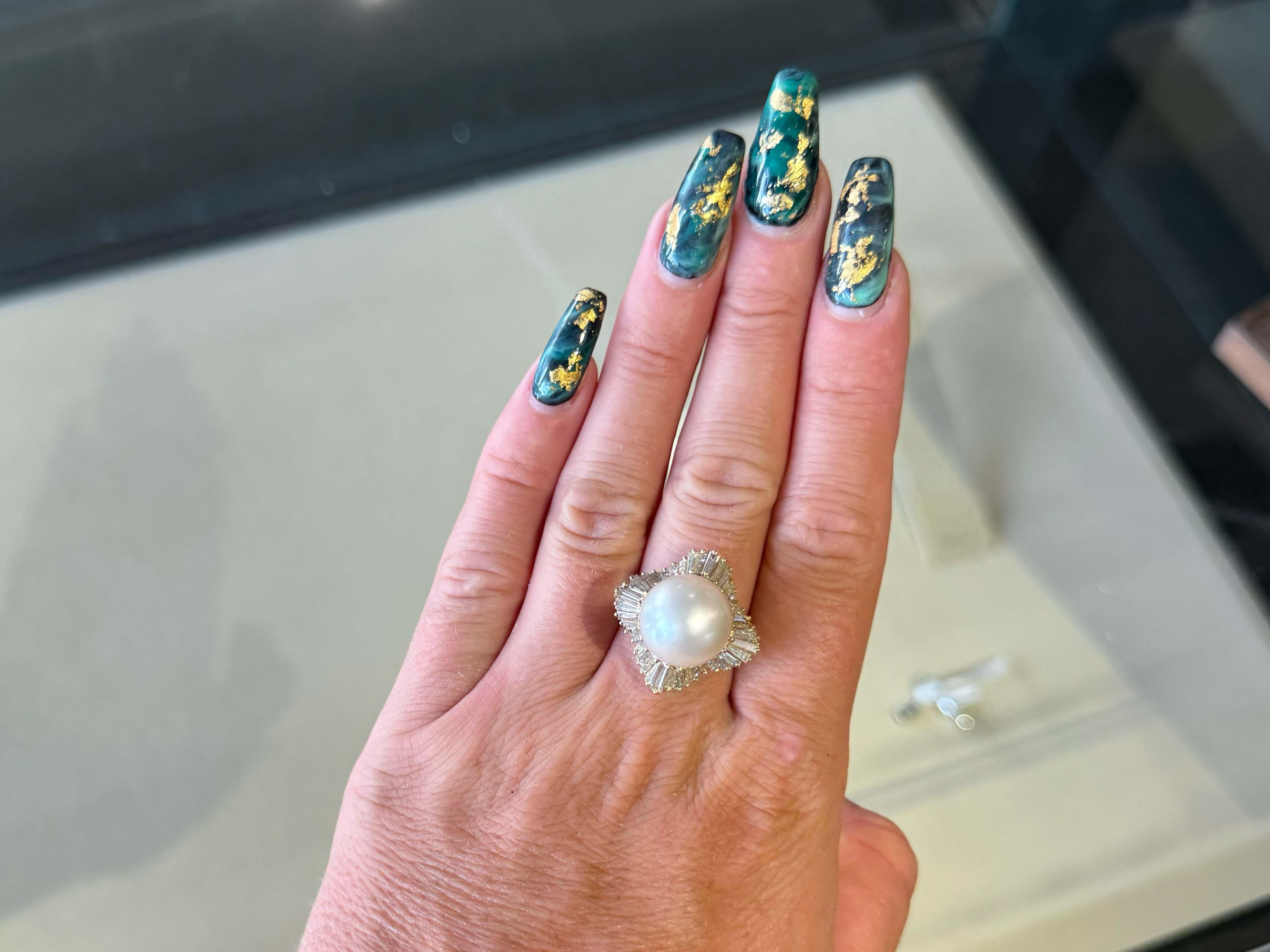 Ring Specifications:

Metal: 14k Yellow Gold

Total Weight: 11.4 Grams

Pearl Diameter: ~14 mm

Pearl Count: 1 south sea pearl

Diamond Count: 24 brilliant cut, 40 baguette

Diamond Color: H-J

Diamond Clarity: VS2-SI2

Diamond Carat Weight: 1.75
