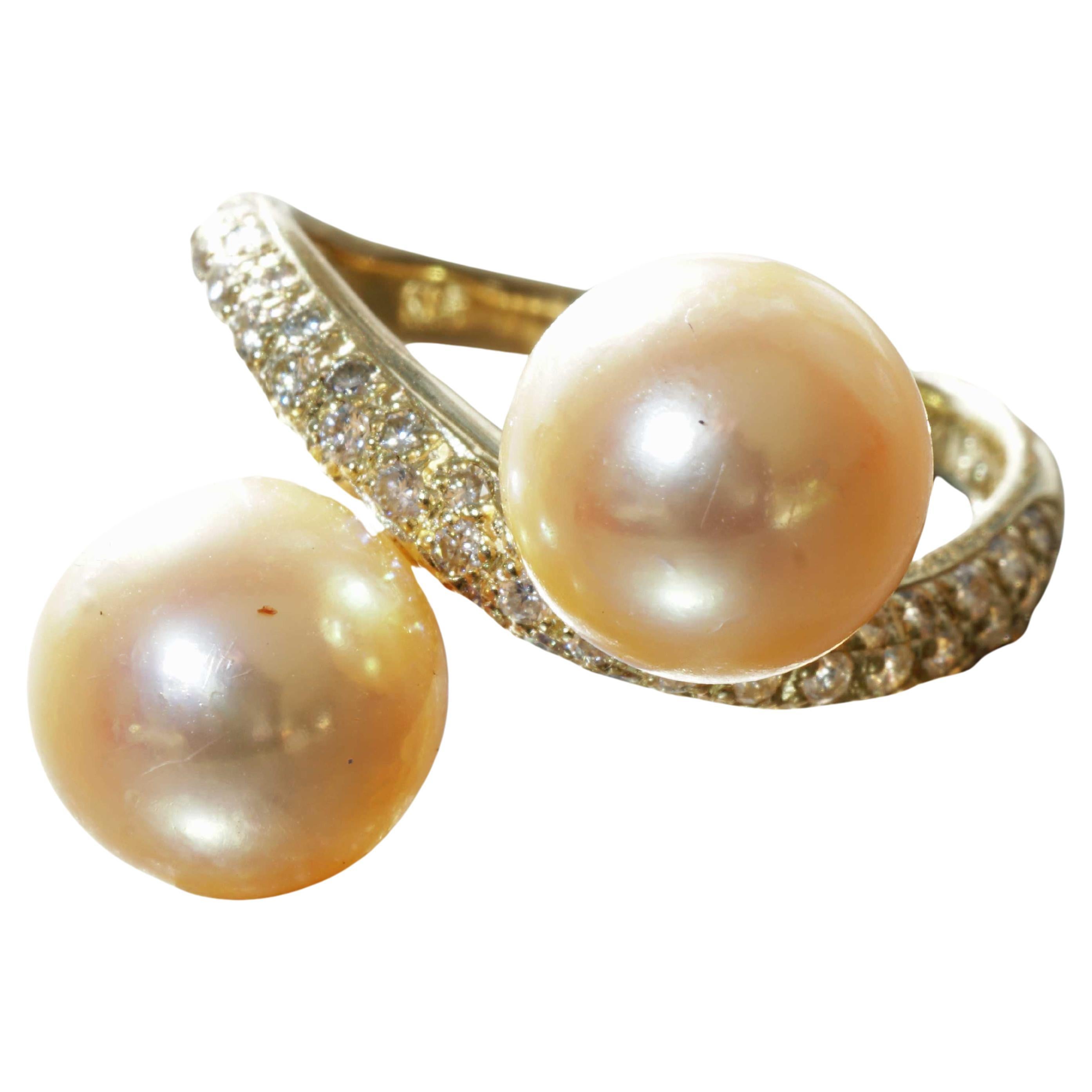 ...elegant style, solidly crafted ring with gold-colored South Sea cultured pearls of 9.3 and 9.6 mm diameter. AAA+ fine luster, and ring shoulders pavee set with full-cut brilliant-cut diamonds totaling approx. 0.51 ct, W (white) / VS-SI (very