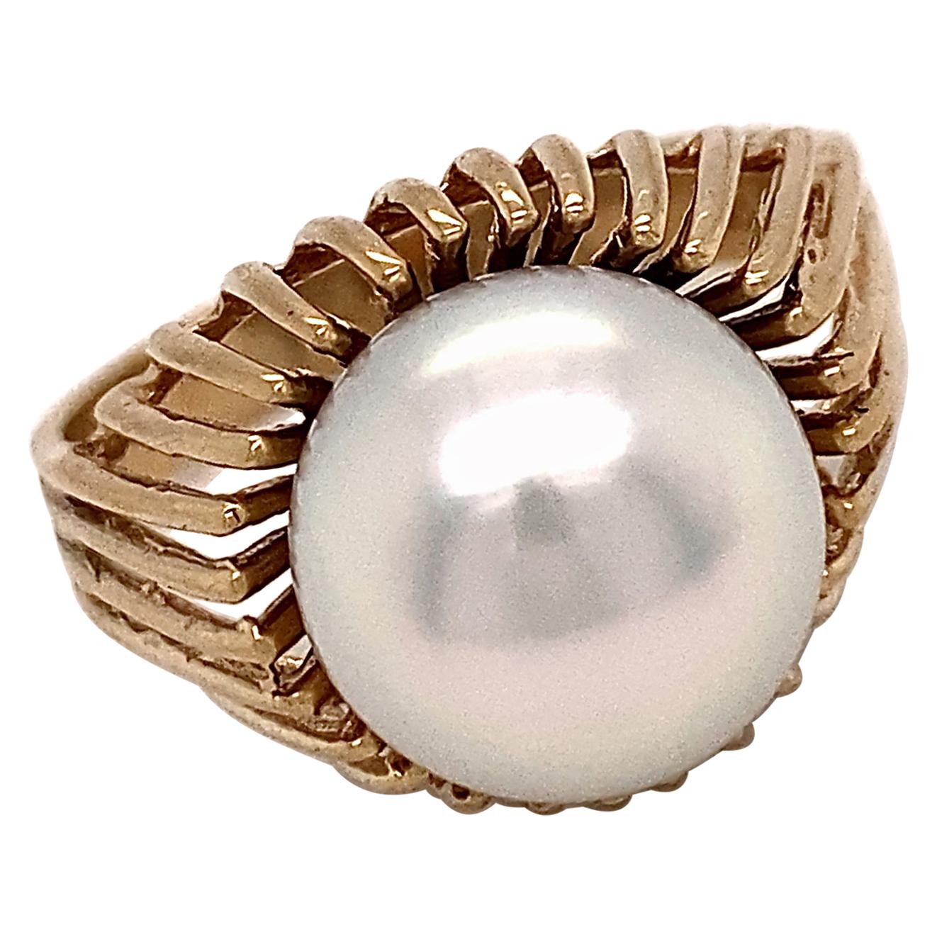 This is a zippy ring we've had for about a zillion years but it originally held a Tahitian pearl.  As much as we love black pearls, they aren't all created equal and this one was a snoozer.  We thought a bright white pearl would be a better fit and