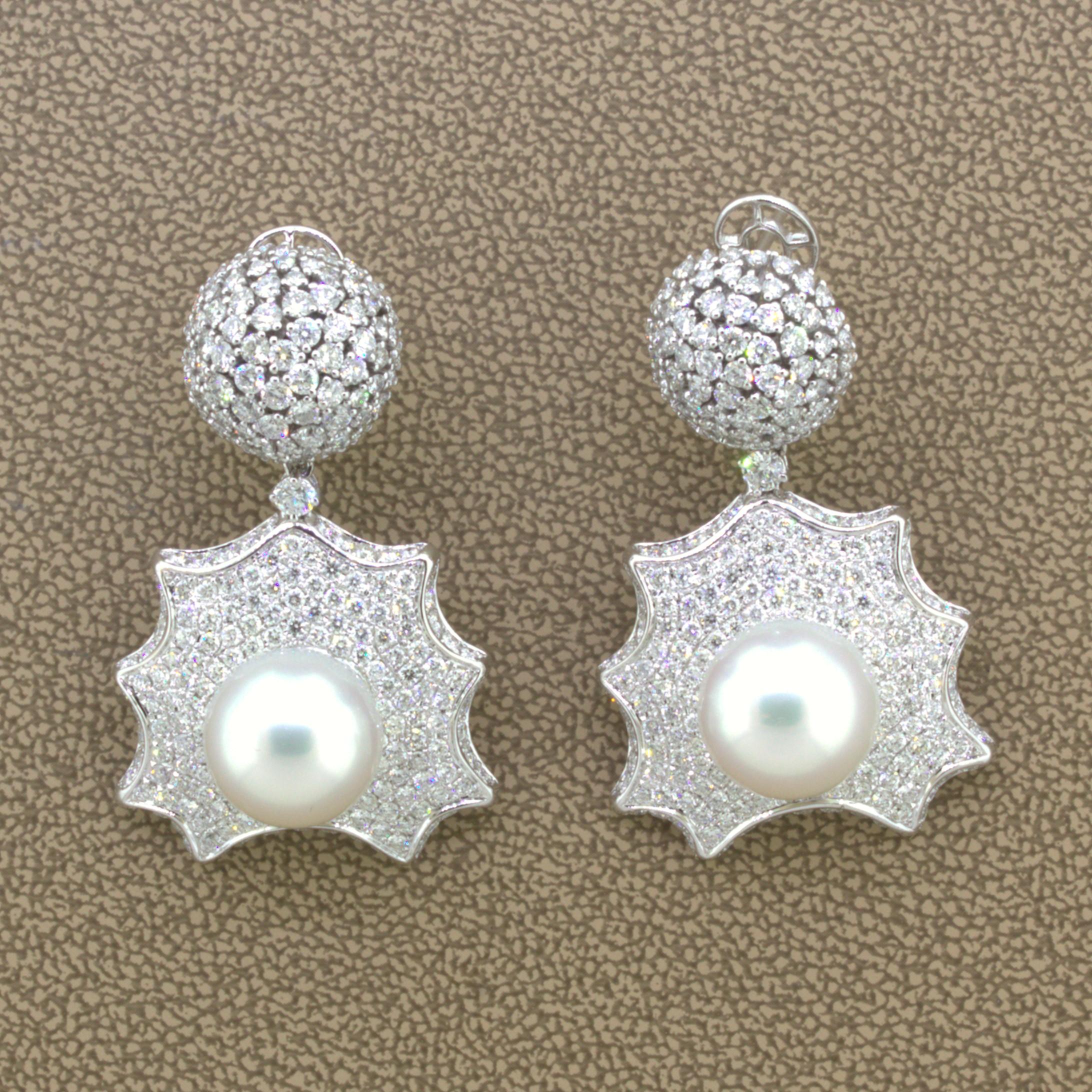 A unique, fun, and stylish pair of fine earrings featuring South Sea pearls and diamonds. The pearls measure 11.5 meters each and have excellent luster, nacre, and color as they are both matching and glowing in the light. They are complemented by