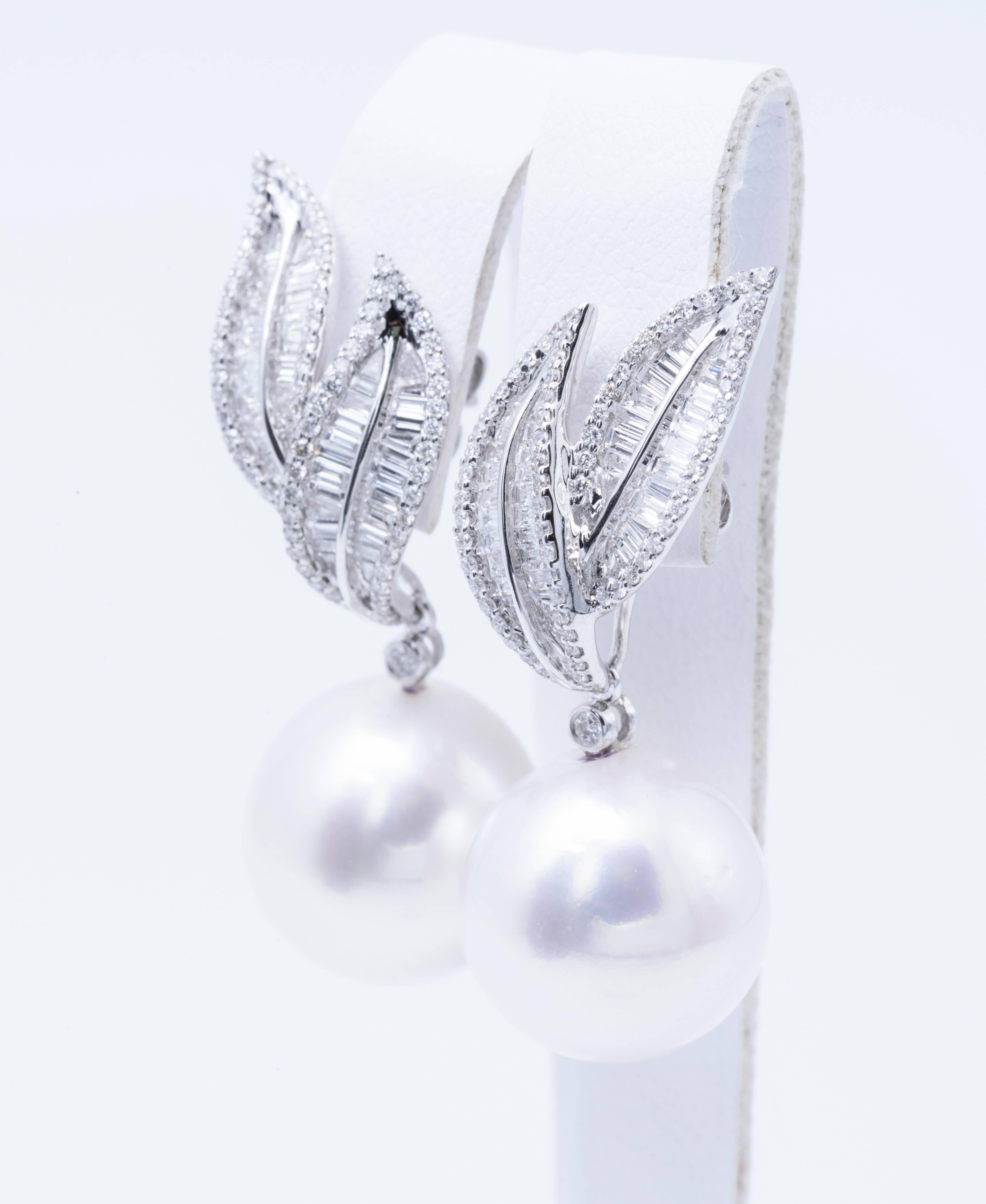 South Sea Pearl drop earrings measuring 14-15 mm with diamond baguettes and round brilliants weighing 1.60 Carats in 18 karat white gold.