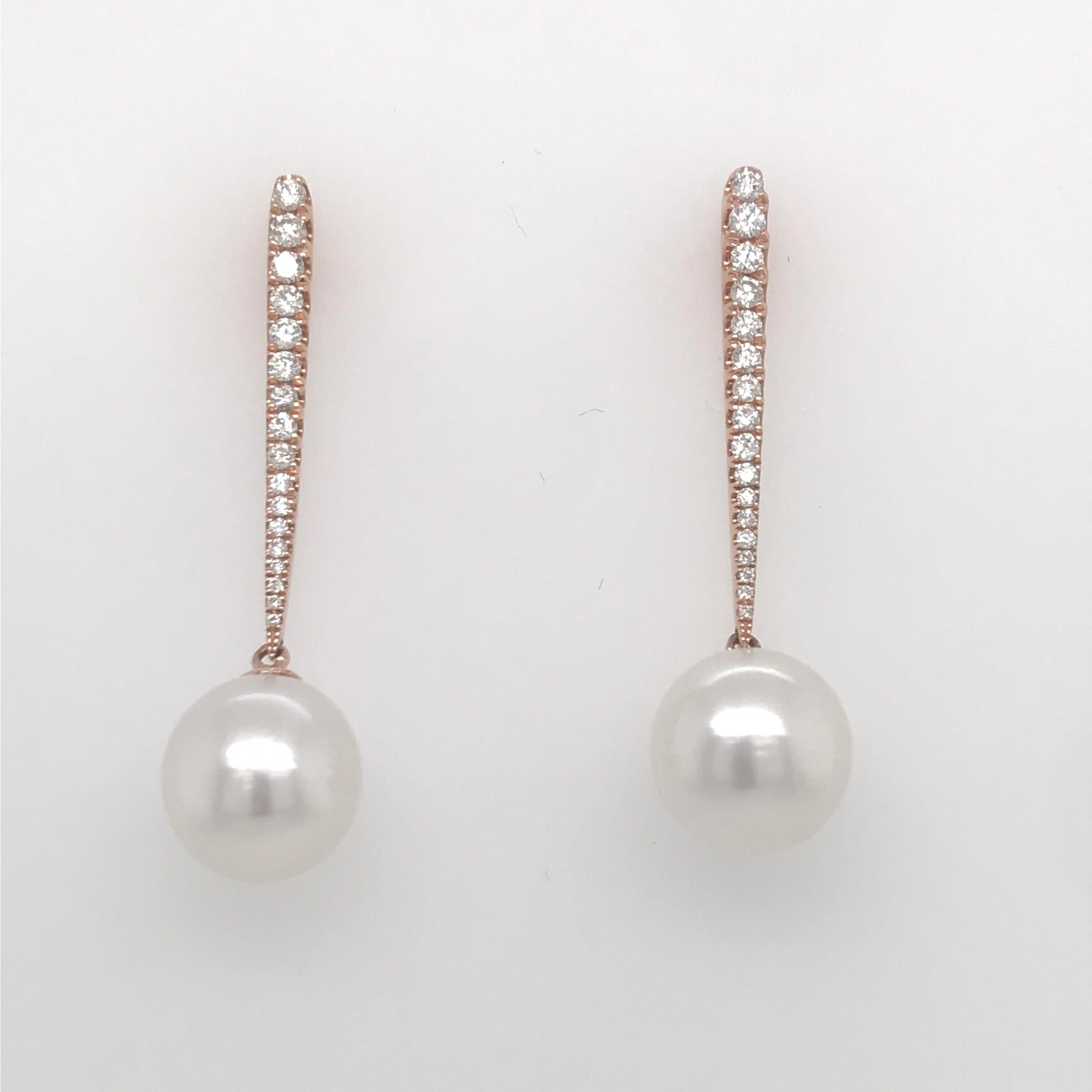 18K Rose Gold earrings featuring two South Sea white pearls measuring 10-11 MM with a diamond bar weighing 0.43 carats.