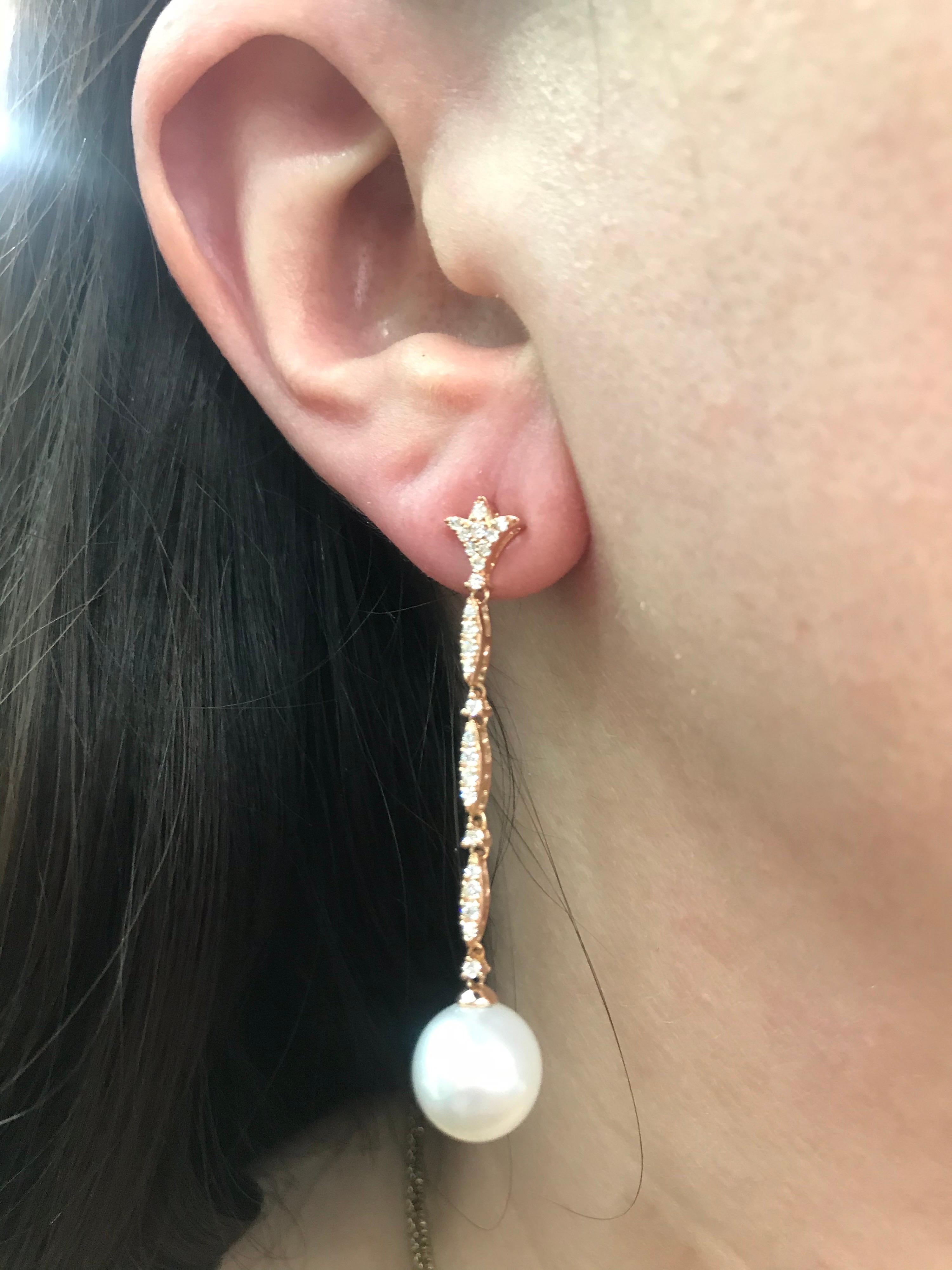 18K Rose gold drop earrings featuring 40 round brilliants weighing 0.42 carats and two South Sea Pearls measuring 10-11 mm. 