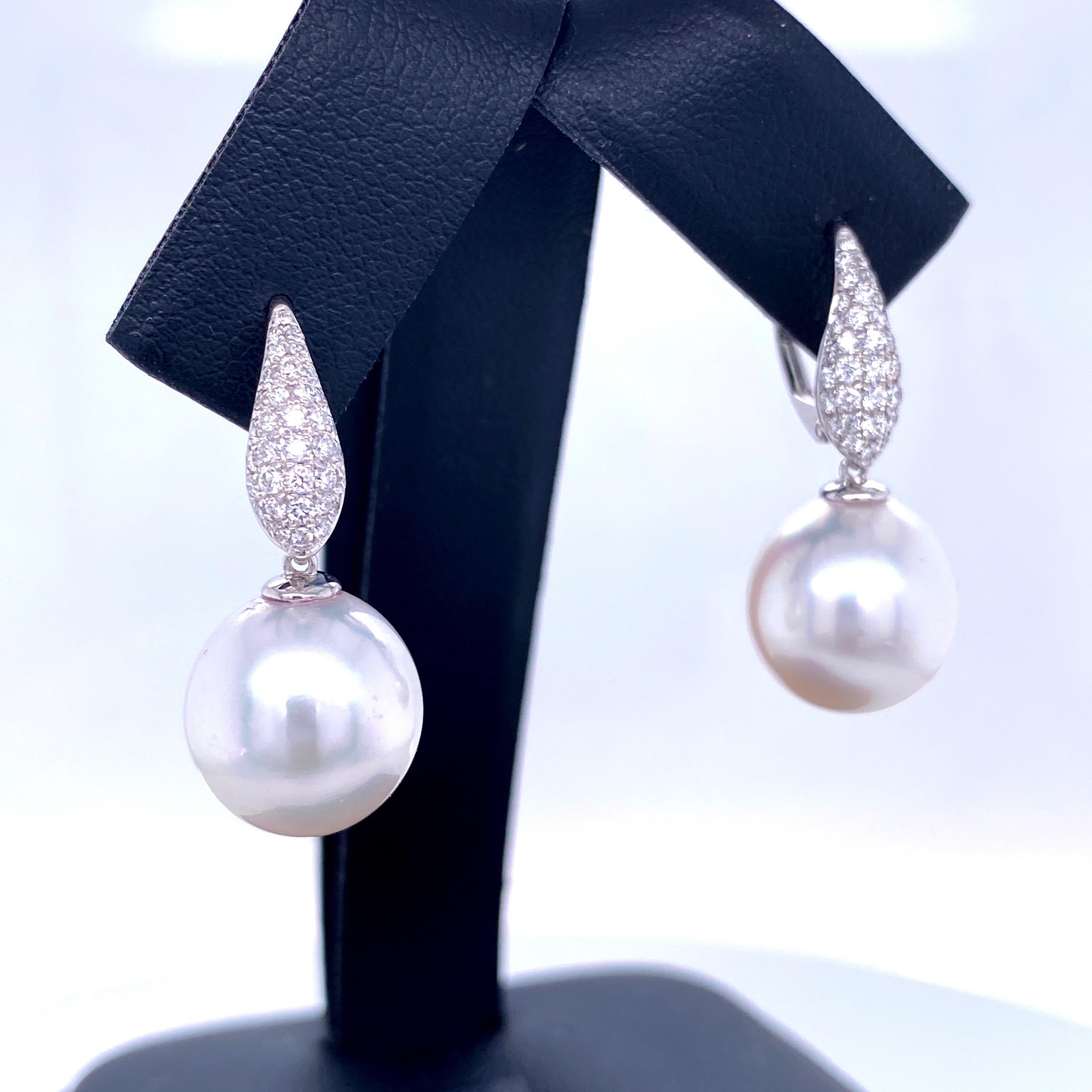 18K White gold drop earrings featuring 70 round brilliants weighing 0.45 carats with two South Sea Pearls measuring 11-12 mm. 
Color G
Clarity SI

Pearl can be changed to Pink, Golden or Tahitian upon request.
Price subject to change. 