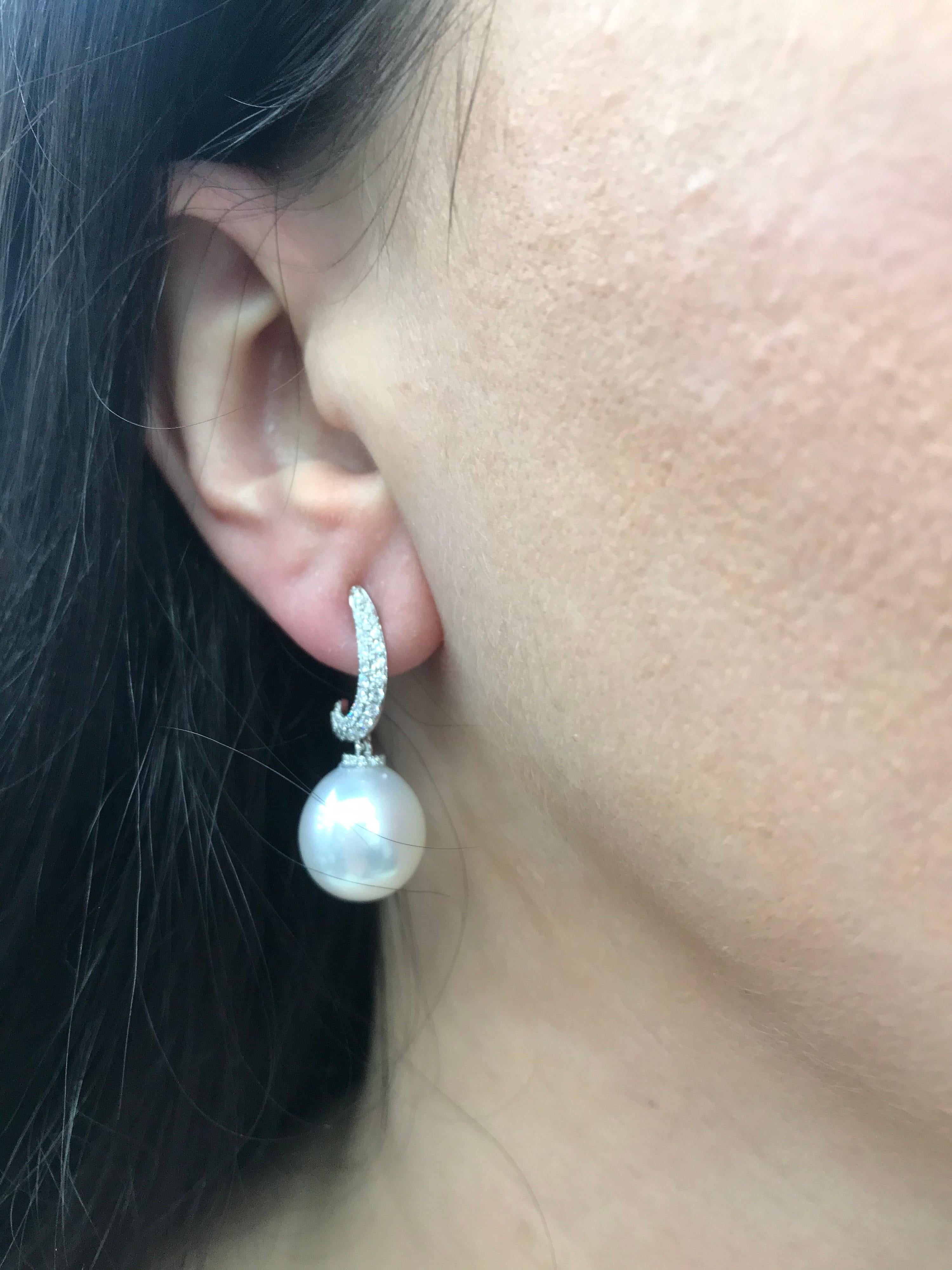 18K White gold drop earrings featuring two South Sea Pearls measuring 12-13 mm with 74 round brilliants weighing 0.48 carats.
Color G-H
Clarity SI