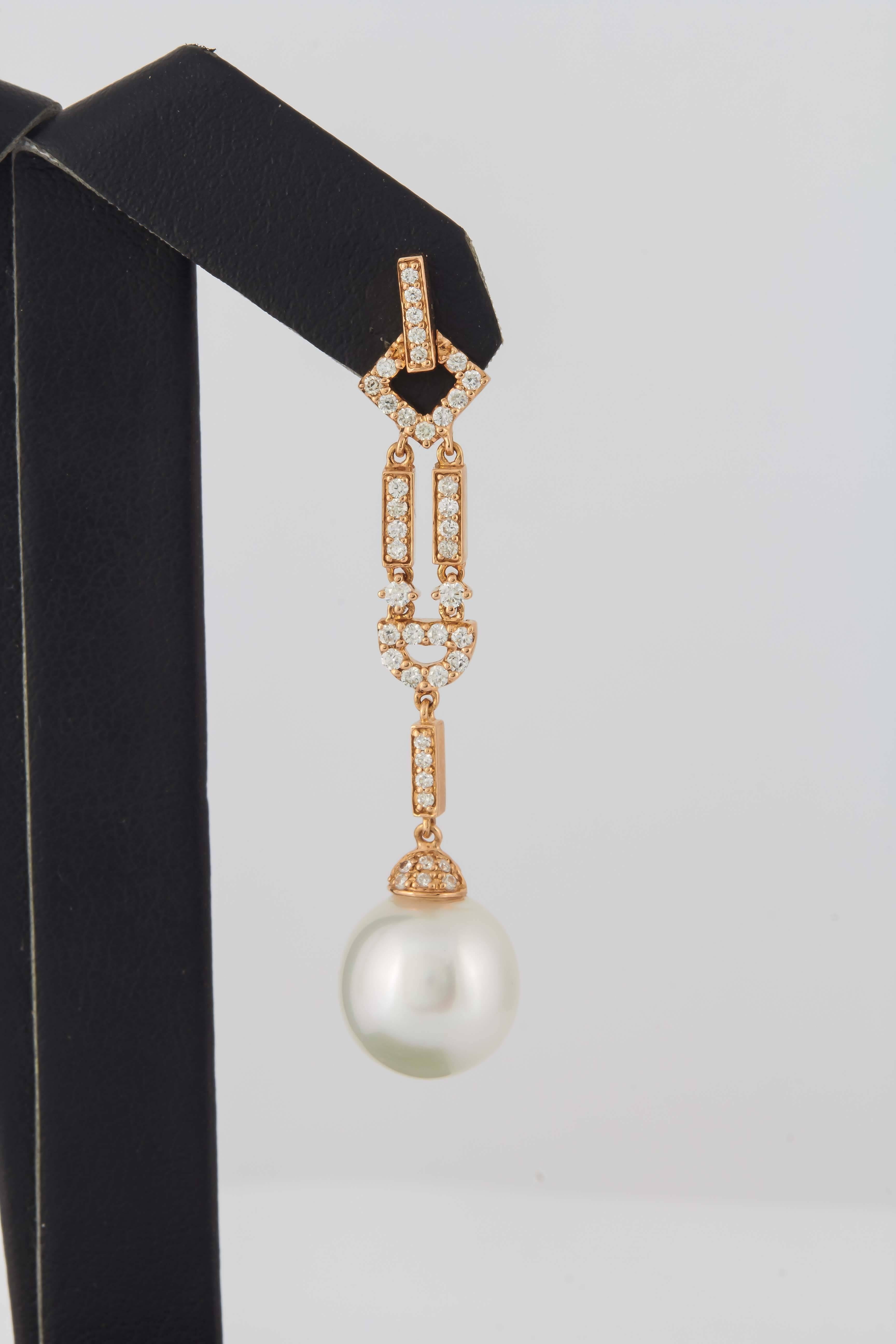 18K Rose gold drop earrings featuring 84 round brilliants weighing 0.76 carats and two South Sea Pearls measuring 11-12 mm. 
Pearl luster: AA
Pearl Quality: AA
