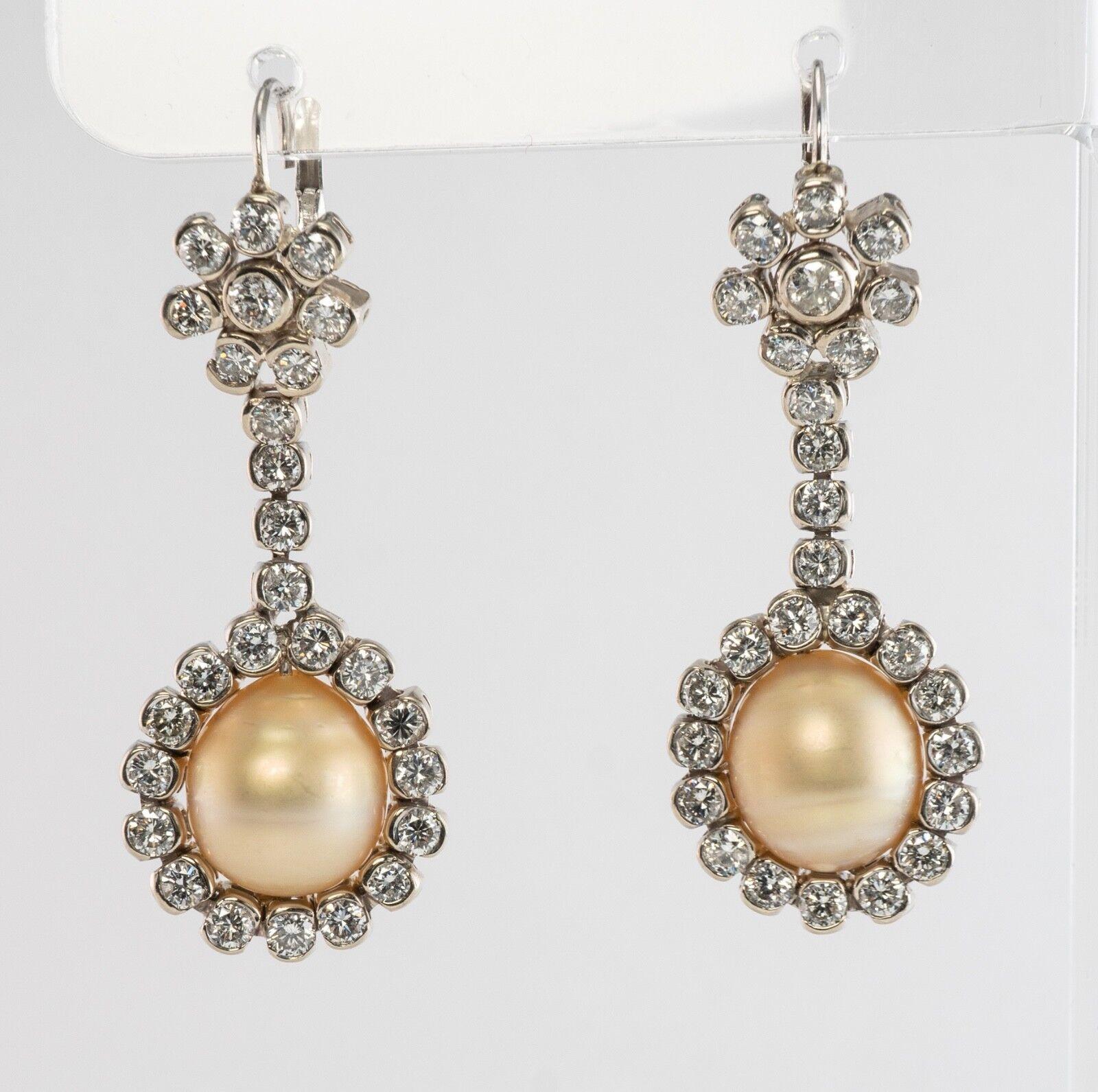This absolutely stunning pair of earrings is finely crafted in solid 14K White Gold. Each cultured natural South Sea Pearl measures 12mm x 11mm. These quality Pearls with light golden undertone has a great luster and skin. Each earring has 27 white