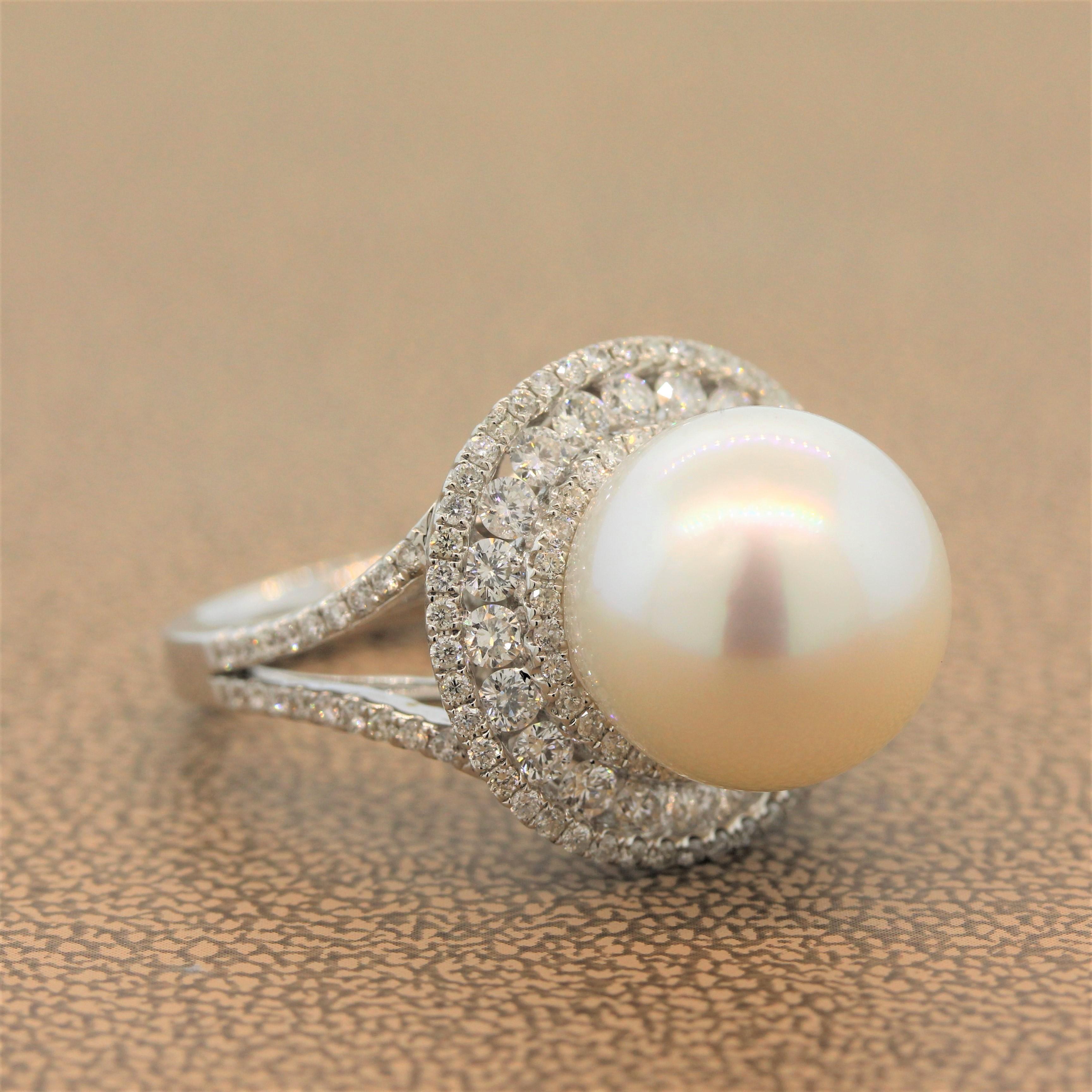 A contemporary ring featuring a flawless 13.5mm South Sea pearl decorated with a  triple halo of 1.76 carats of round cut diamonds that flows over the split shank. This gleaming ring is set in 18K white gold.

Ring Size 6.5 (Sizable)
