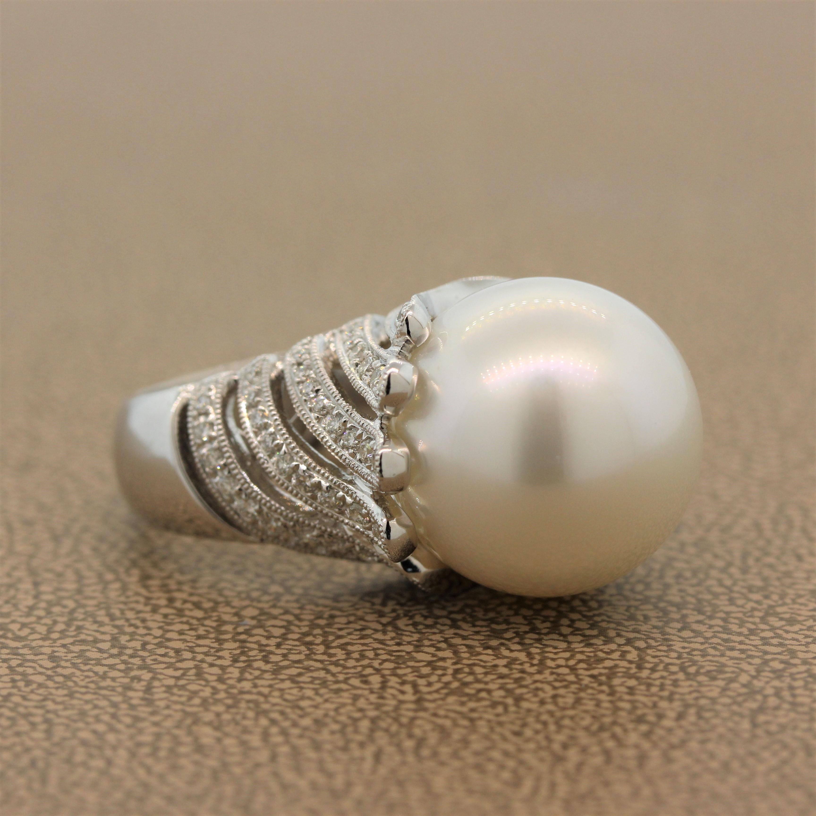 An astounding lustrous blemish free 17.5mm-18.0mm South Sea pearl sitting high in an 18K white gold setting. The feather-like milgrain design is set with 0.84 carats of round cut diamonds. An unassuming cocktail ring with glamor and elegance.

Ring