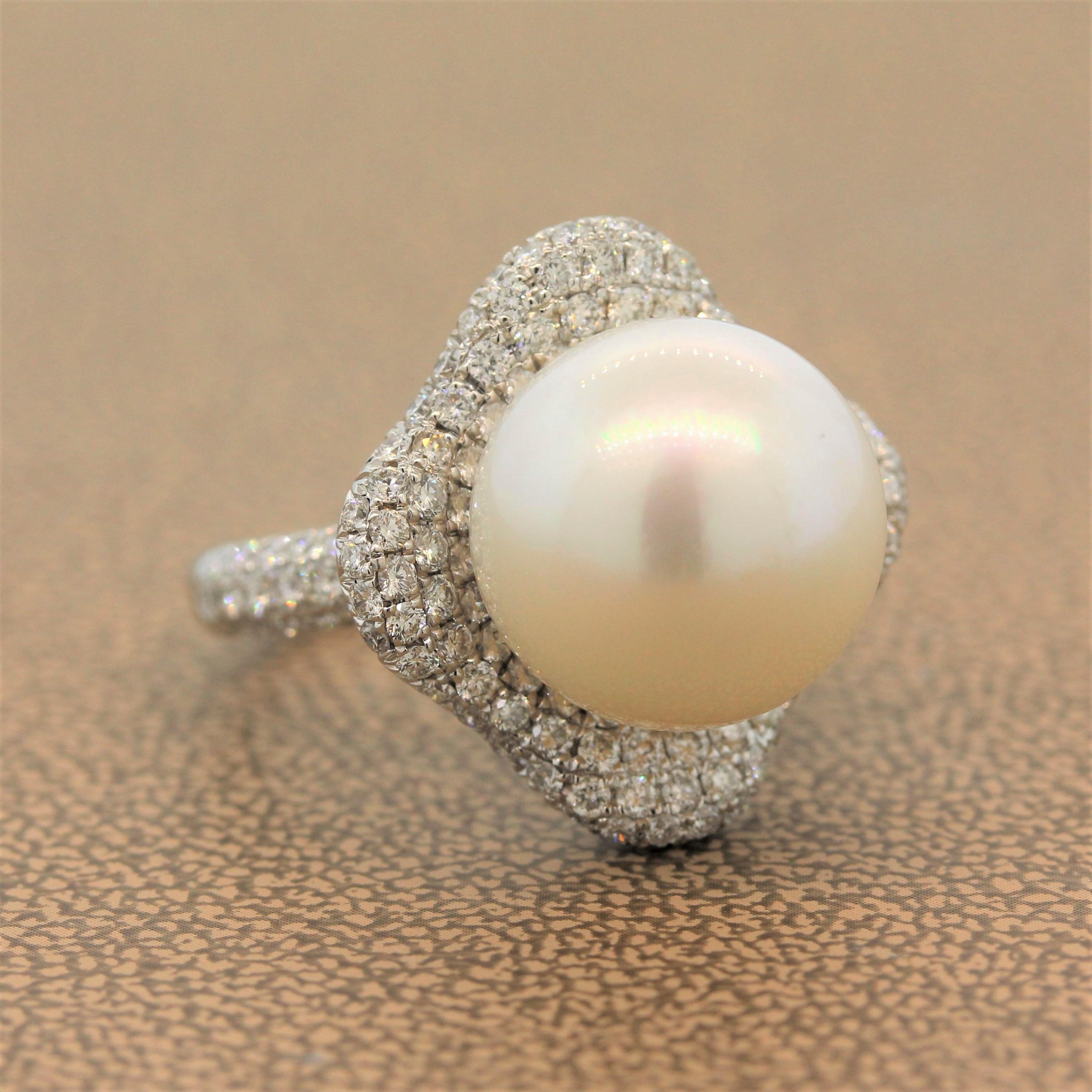 A perfectly round South Sea pearl sits in the center of this concave 18K white gold ring. The wavering halo features 2.36 carats of round cut pave set diamonds illuminating the lustrous pearl.

Ring Size 6.75
