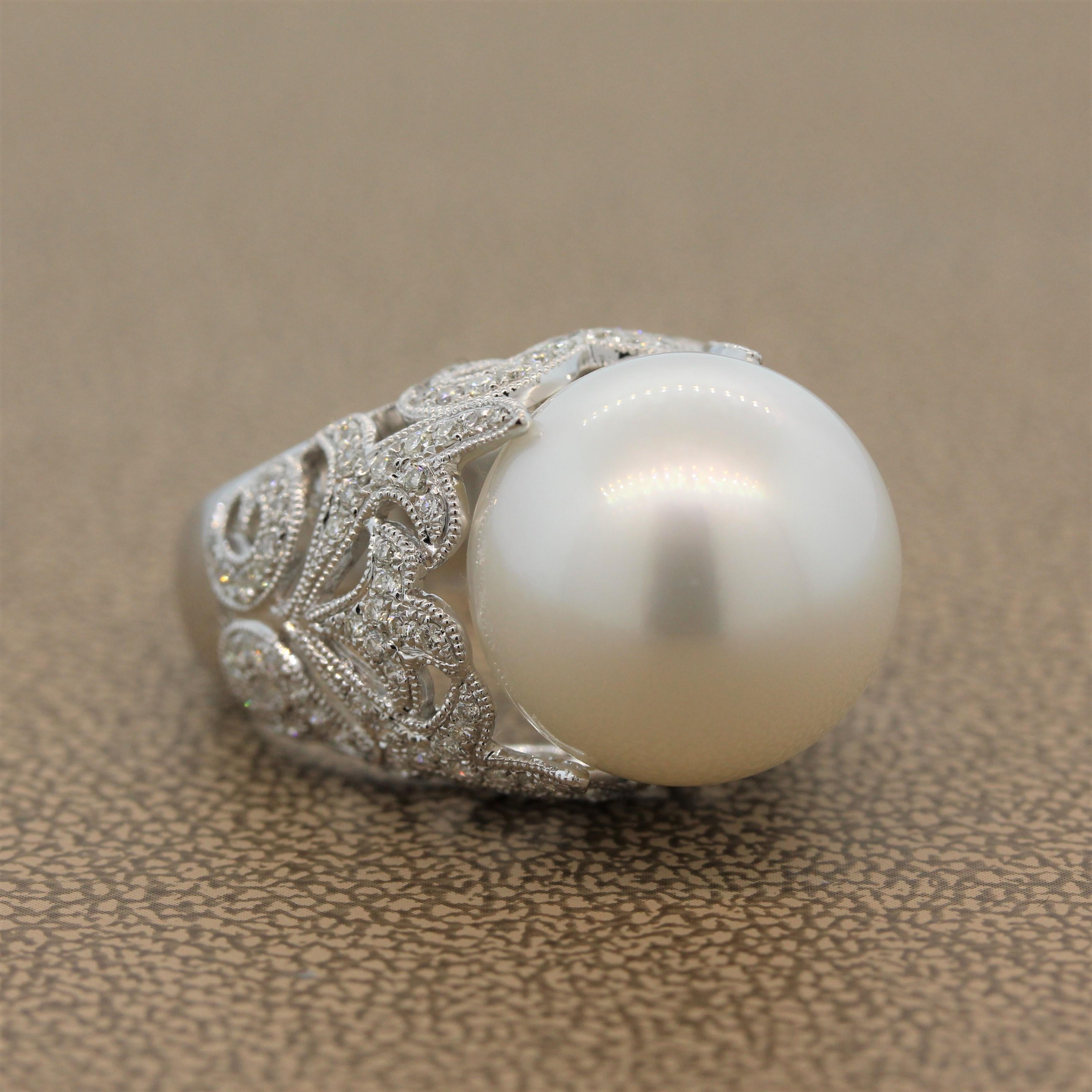 A luminous 15.5mm-16mm South Sea pearl surrounded by 0.75 carats of VS quality diamonds. The colorless round cut diamonds are set in a lavish 18K white gold filigree ring with a milgrain design.  

Ring Size 6.75 (Sizable)
