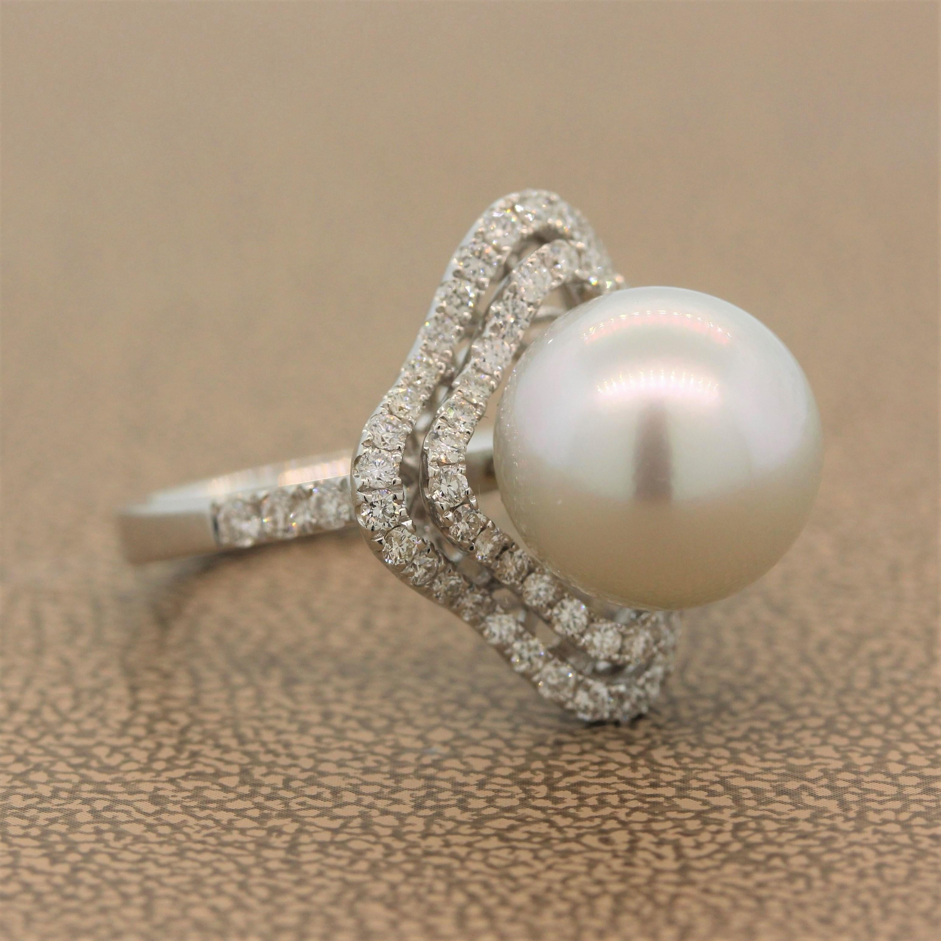 This beautiful ring features a glossy 12mm South Sea pearl surrounded by a double wavering halo of 1.16 carats of diamonds. The colorless round cut diamonds are set in an 18K white gold setting.

Ring Size 6.5 (Sizable)
