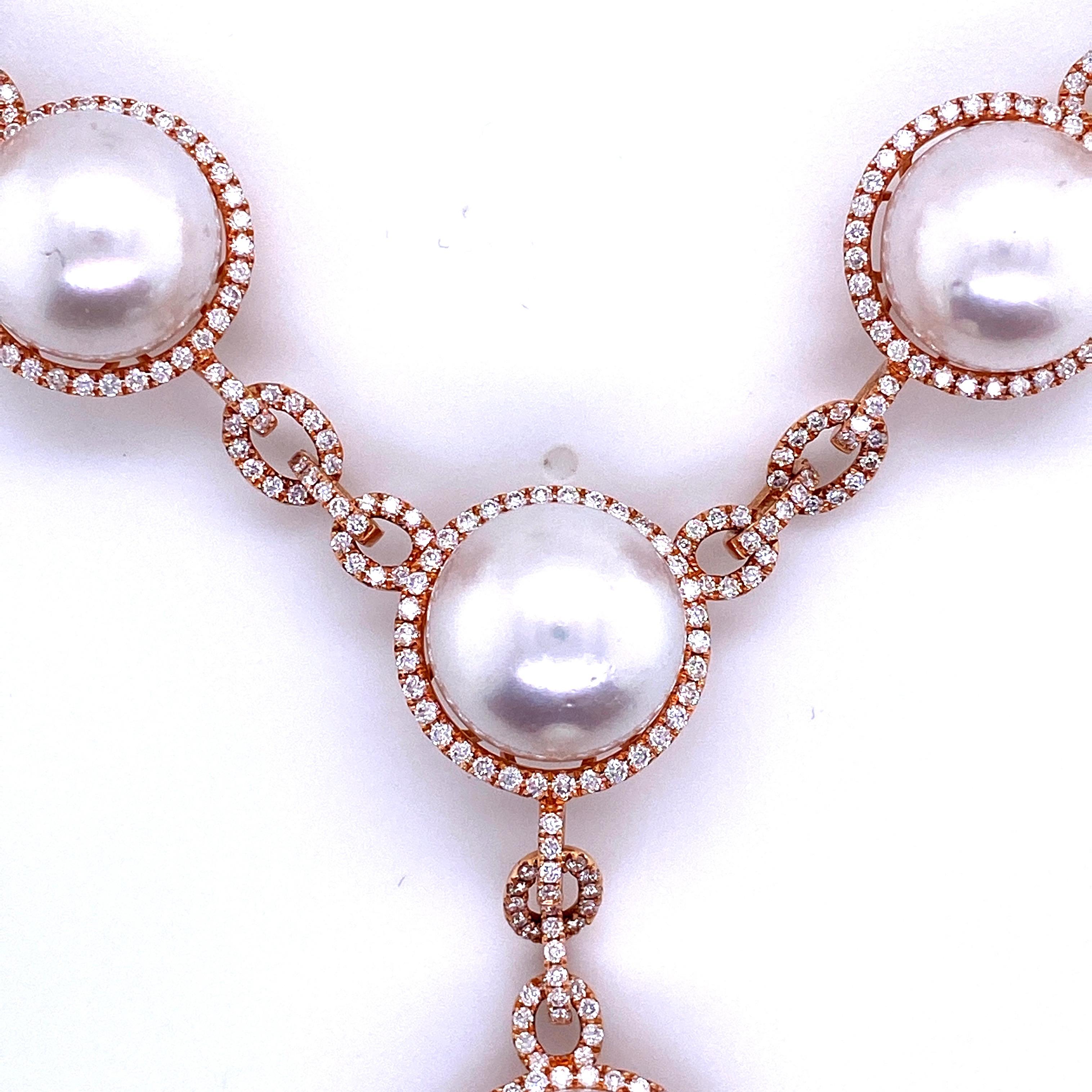 Impressive 18K Rose gold drop necklace featuring 8 South Sea Pearls measuring 13-15 mm flanked with numerous round brilliants in a halo and link motif weighing 4.20 carats. 
Color G-H
Clarity SI

Measurements:
Pearl Drop 1.50 Inches
Halo 0.75