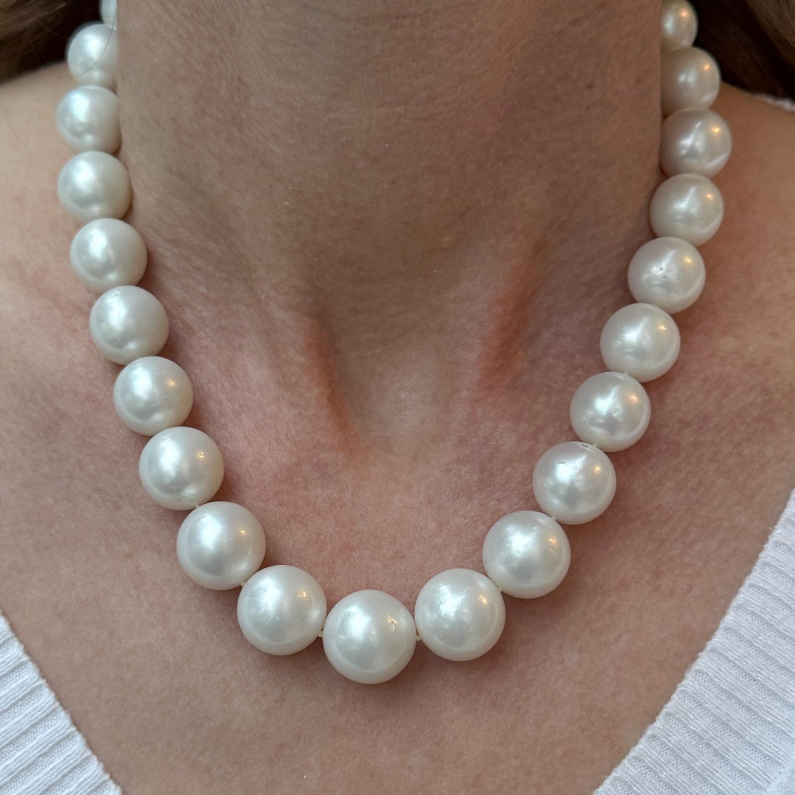 This elegant strand of South Sea pearls is crafted with luminous pearls ranging from 12.8 to 16 mm in size, known for their exceptional luster and rich, creamy tones. The necklace is finished with a stunning 18-karat white gold ball clasp, encrusted