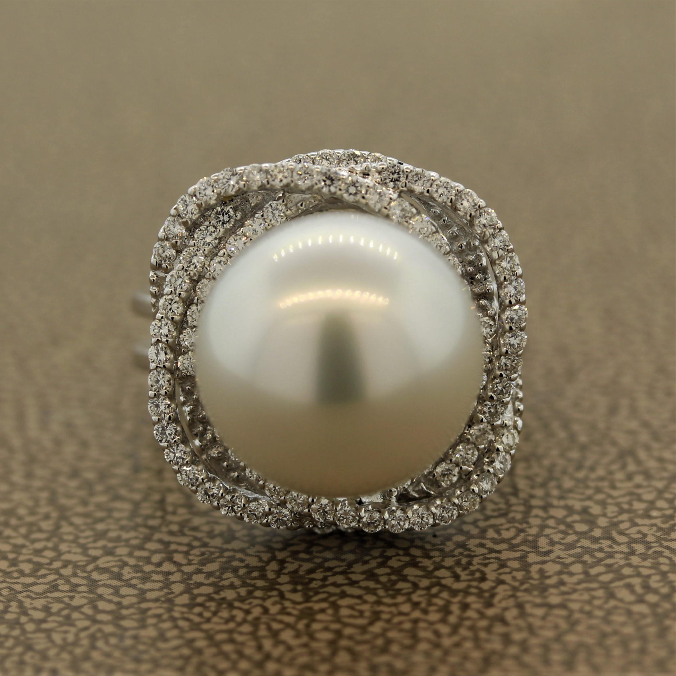 The three overlapping orbit halo design makes this ring truly one of a kind.

It is accented by 0.64 carats of round brilliant cut diamonds.

Adding distinction to it is a stunning 14mm, no blemish south sea pearl as the center stone.

The ring is