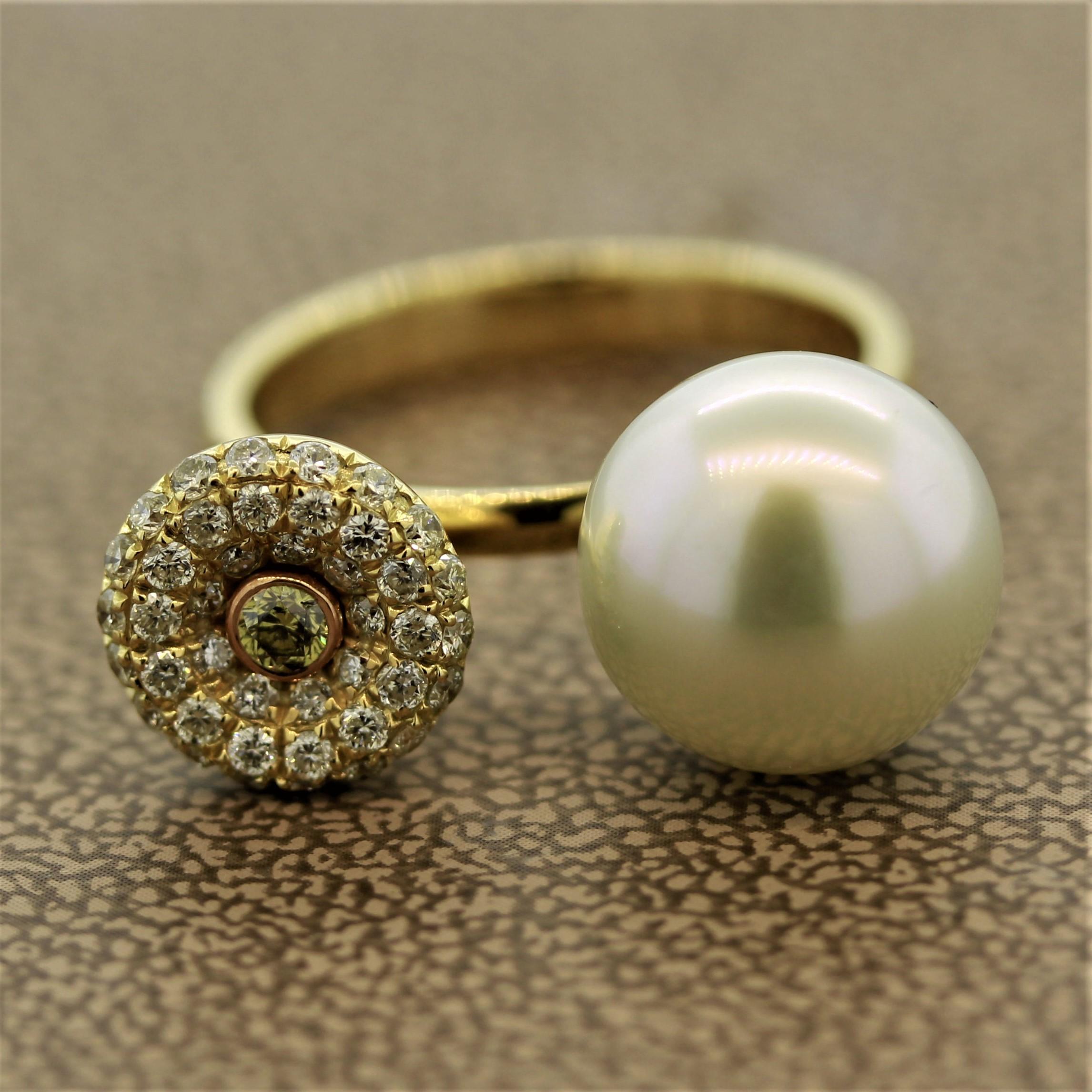 A unique ring featuring a South Sea pearl and fancy colored diamonds. The pearl has a full plump shape with an excellent luster and soft pink overtone. On the other side are 0.69 carats of white and fancy green colored diamond set in 18k yellow