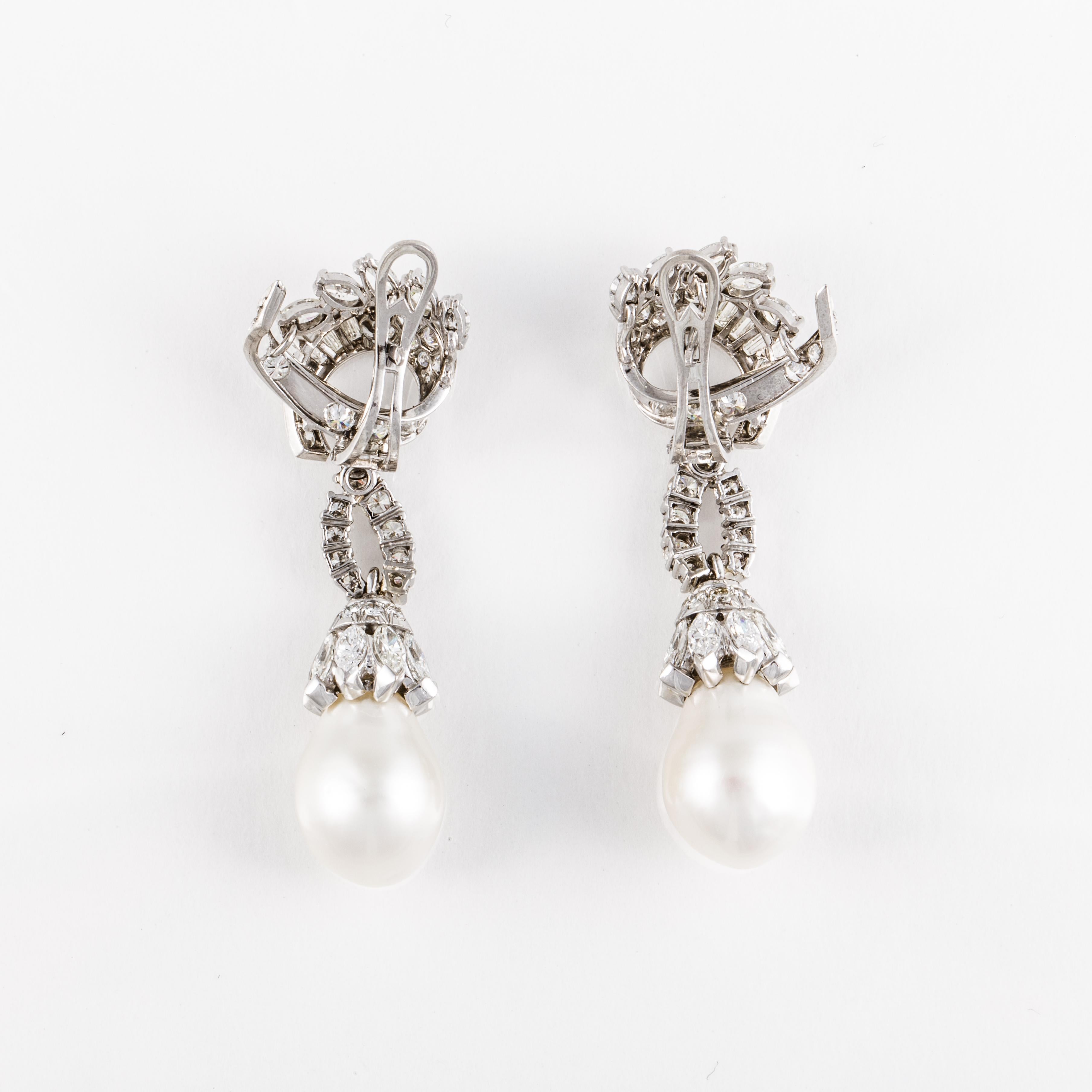 Platinum South Sea pearl and diamond drop earrings.  The two South Sea pearls measure 11.5mm.  There are round, marquise and baguette diamonds that total 5.50 carats; G-I color and VVS-SI clarity.  Measure 1 7/8 inches long and 3/4 inches wide. 