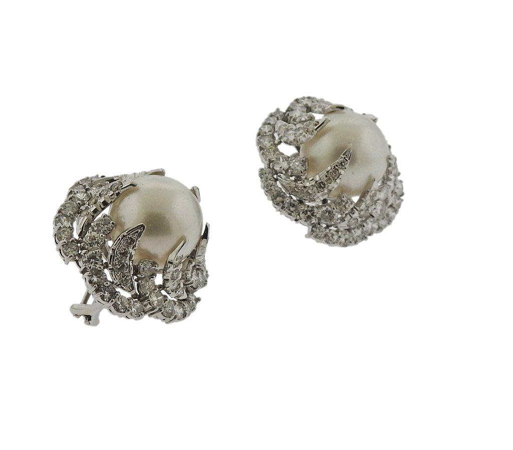Pair of large and impressive platinum earrings, set with approx. 6.20ctw in diamonds, surrounding 14.5mm South Sea pearls. Earrings measure 27mm x 29mm and weigh 33.6 grams.