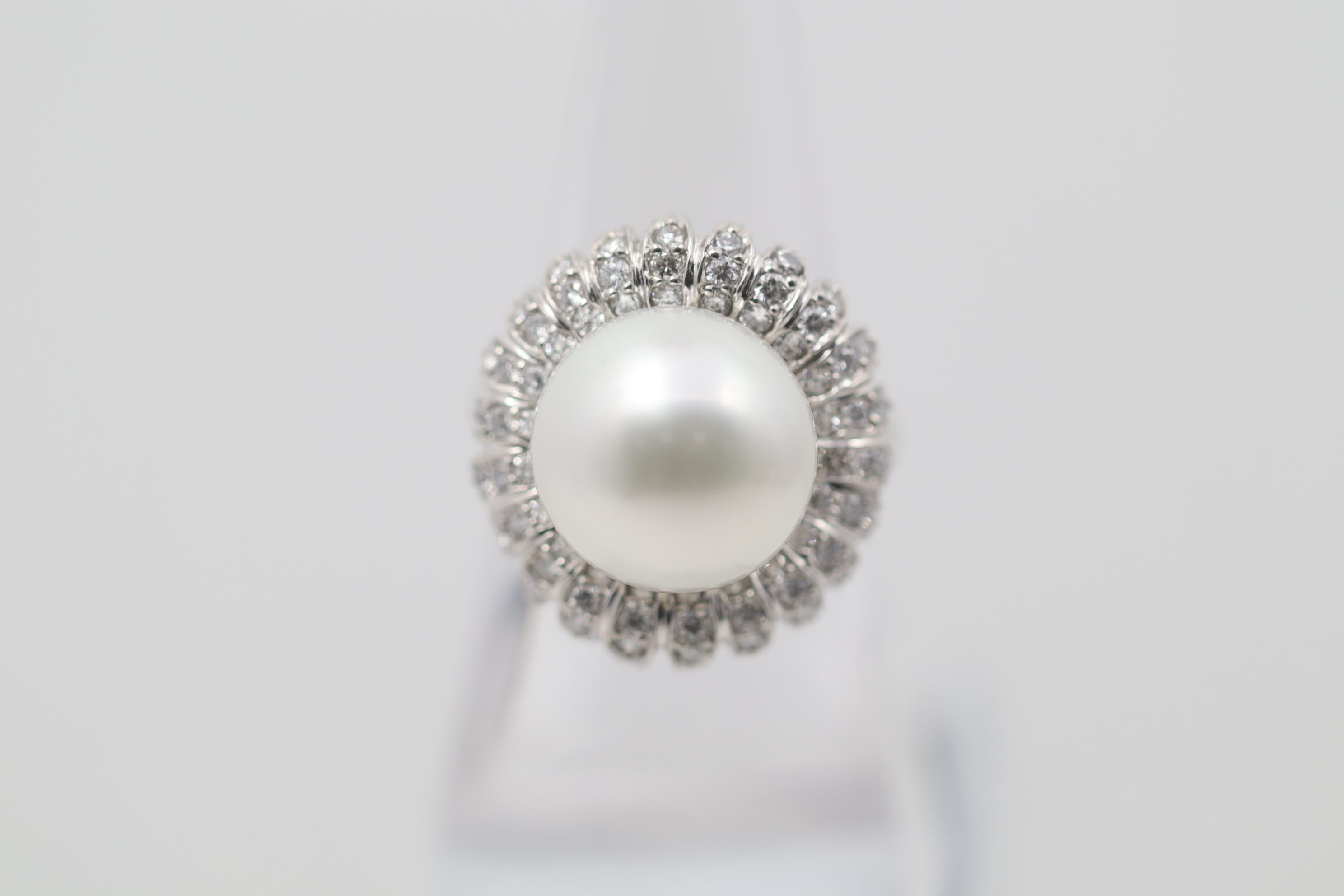 A lovely south sea pearl and diamond flower ring. The pearl measures 13mm and has great luster and is blemish free. It is accented by 0.86 carats of diamonds set around the pearl in a floral pattern. Hand-fabricated in platinum and ready to be