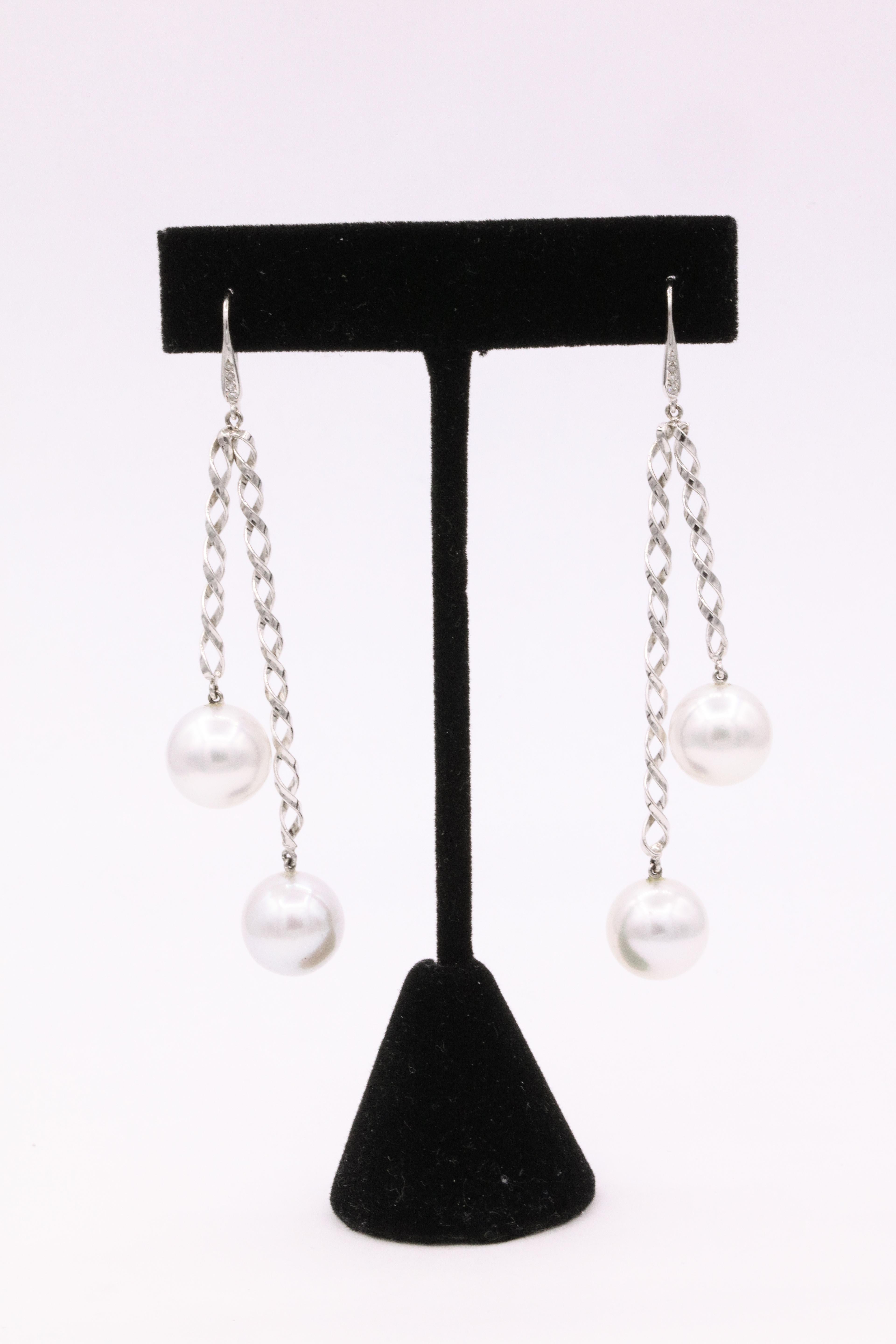 14K White gold swirl earrings featuring 8 round diamonds weighing 0.10 carats and four South Sea pearls measuring 12 mm. 
Can be worn day or night! 