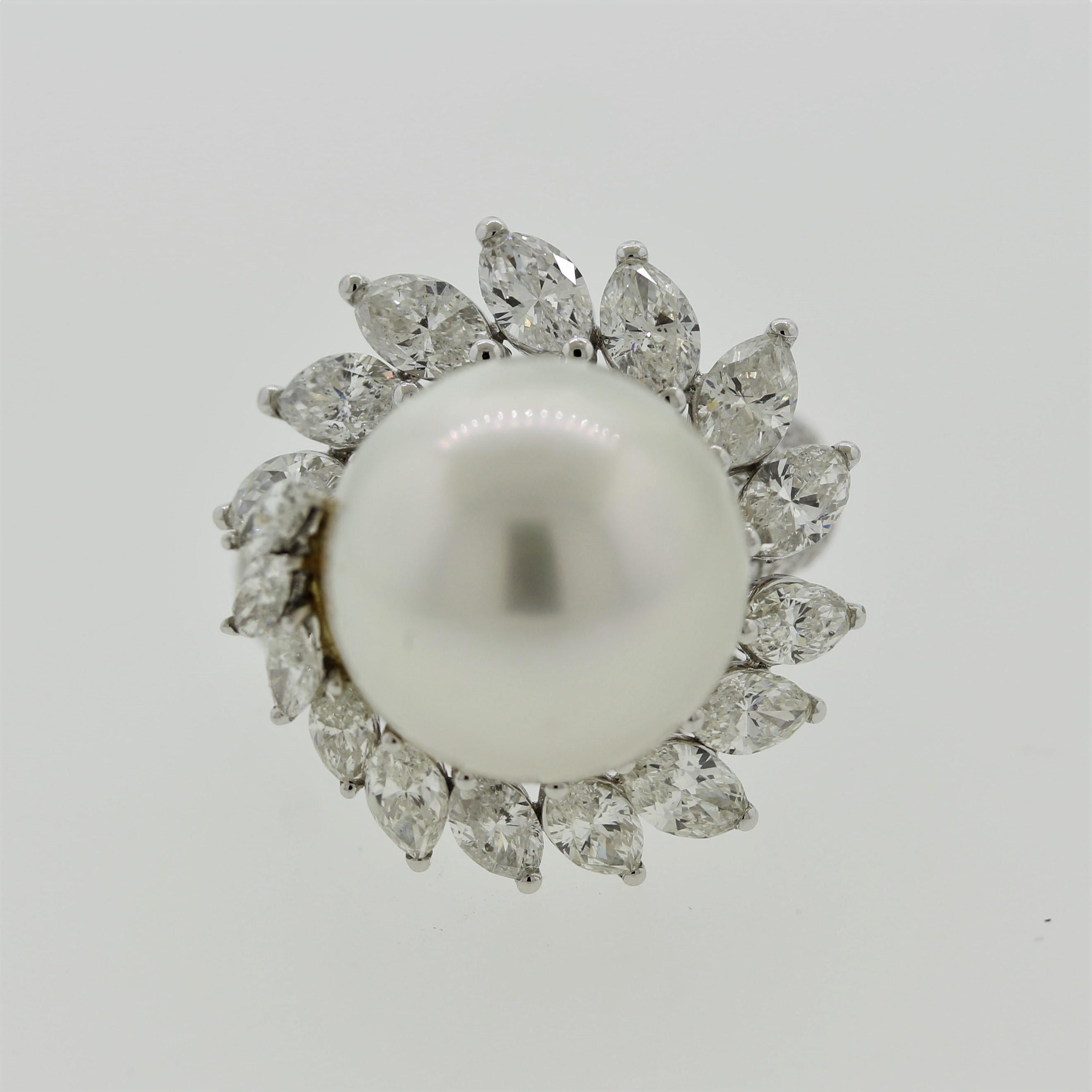 A dazzling cocktail ring featuring a 15mm south sea pearl with a soft pink overtone. It is complemented by a swirl of large pear-shape diamonds running around the pearl along with round brilliant-cuts pave-set down the shoulders of the ring,