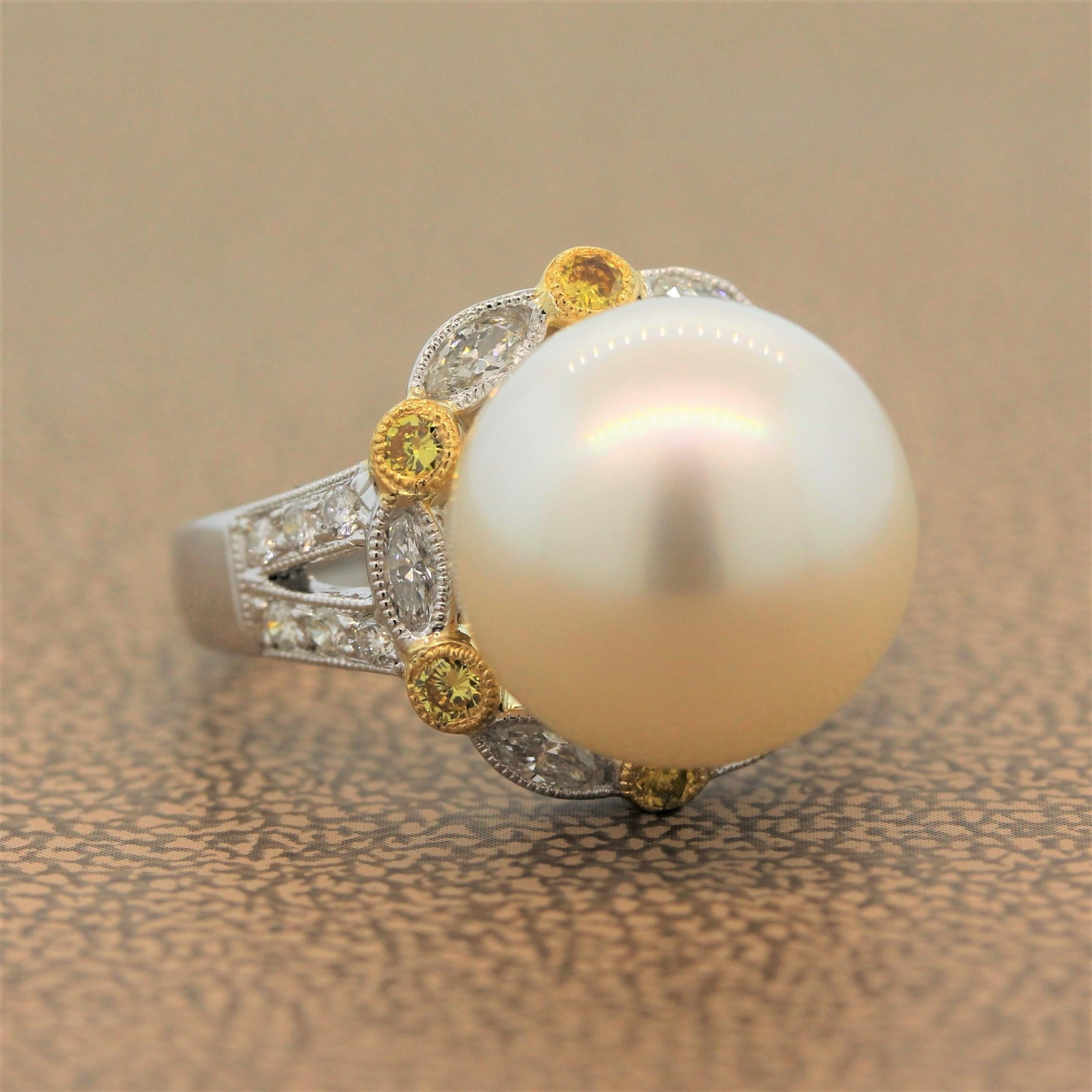 A sweet ring featuring a blemish free South Sea pearl accented by a halo of 0.75 carats of marquise cut diamonds set in platinum alternating with round cut fancy yellow round cut diamonds set in 18K yellow gold. The split shank and the milgrain